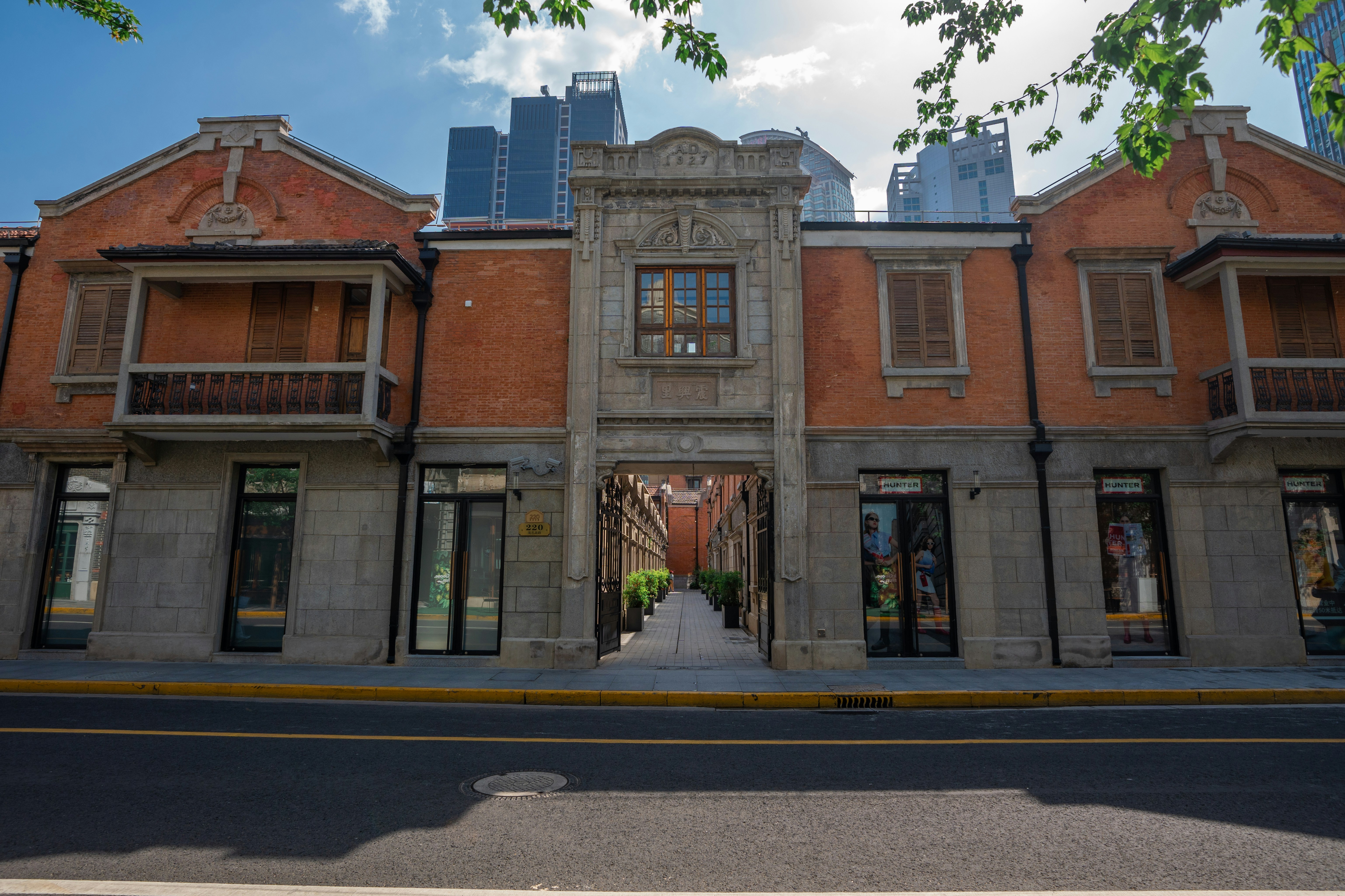 Historic brick building with modern skyscrapers behind