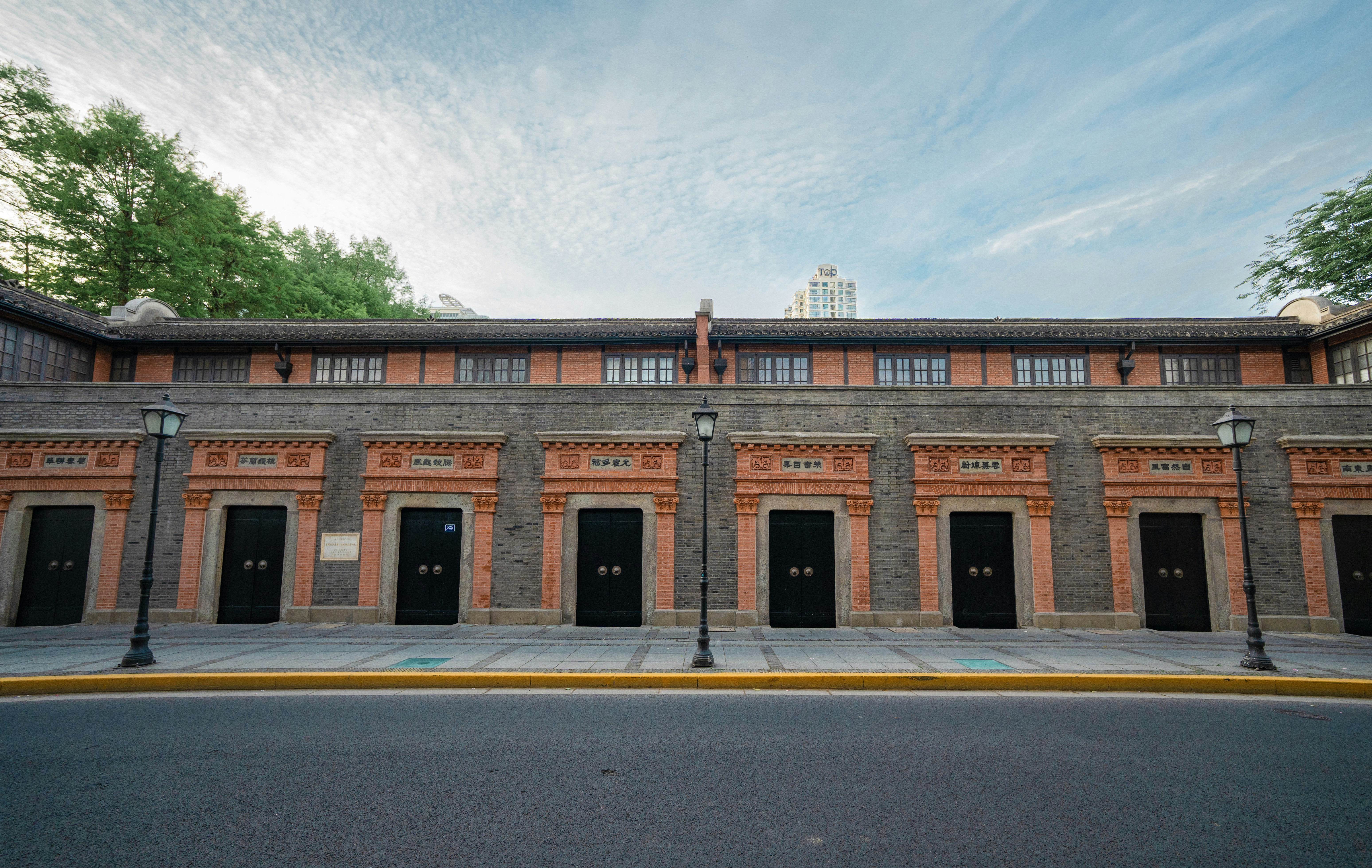 Row of identical doors on a brick building facade.