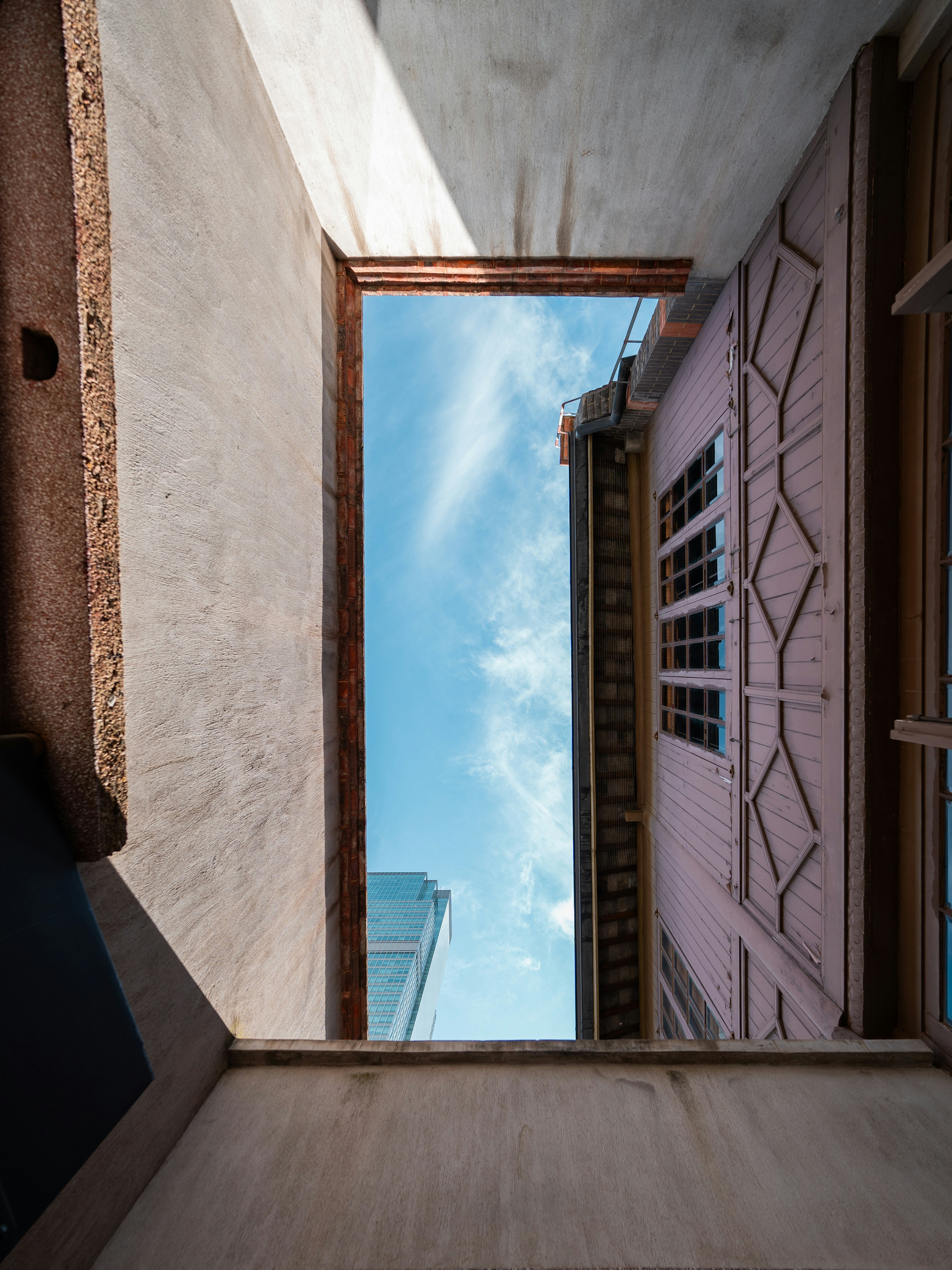 Looking up at sky between buildings
