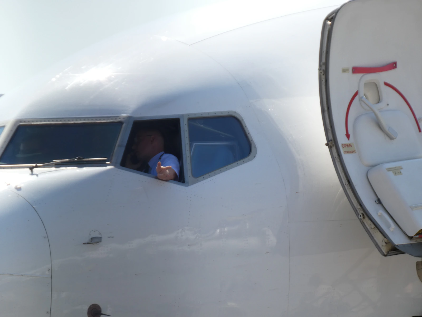 An airline pilot in the cockpit window