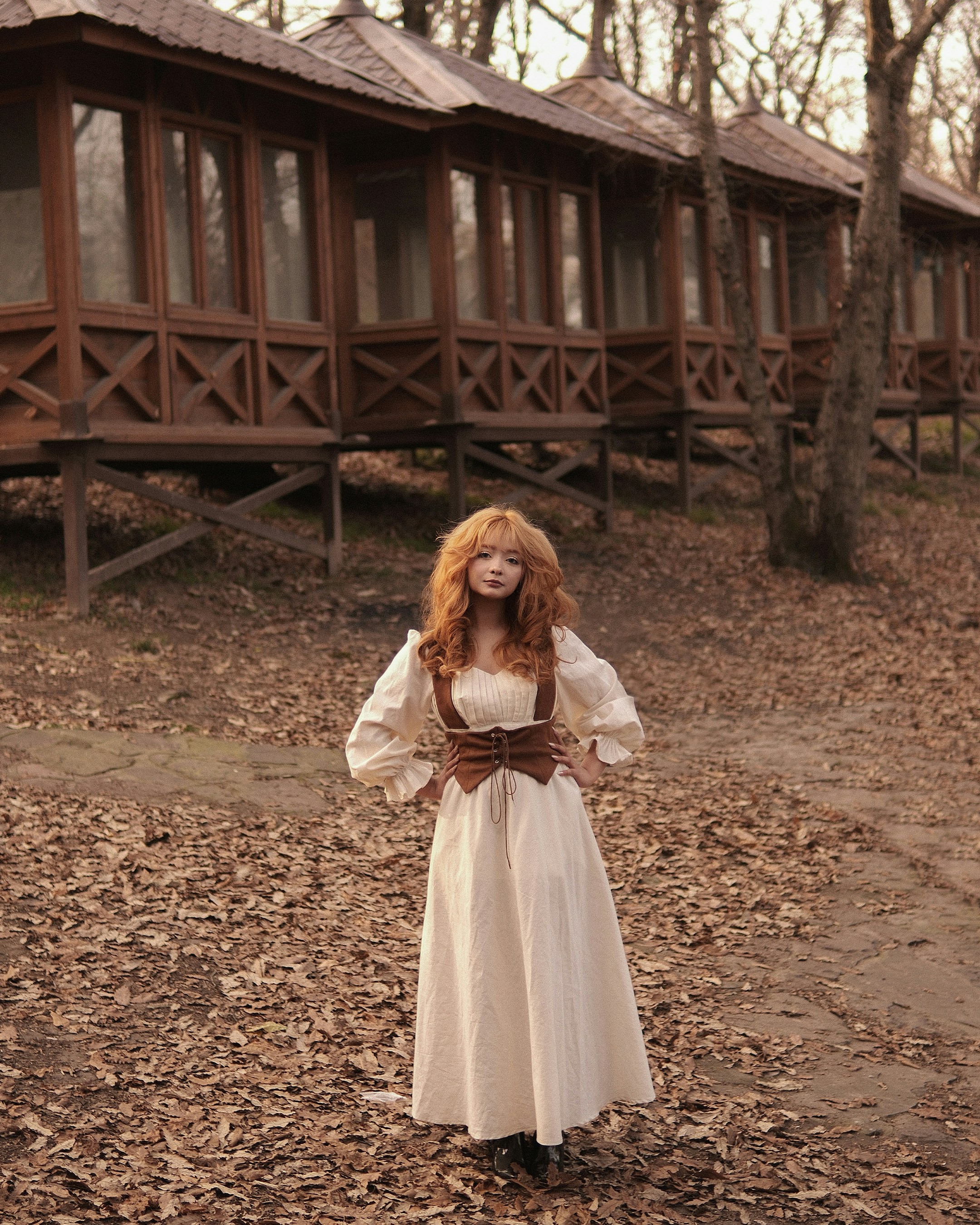 Cream dress with corset belt at a woodland cabin