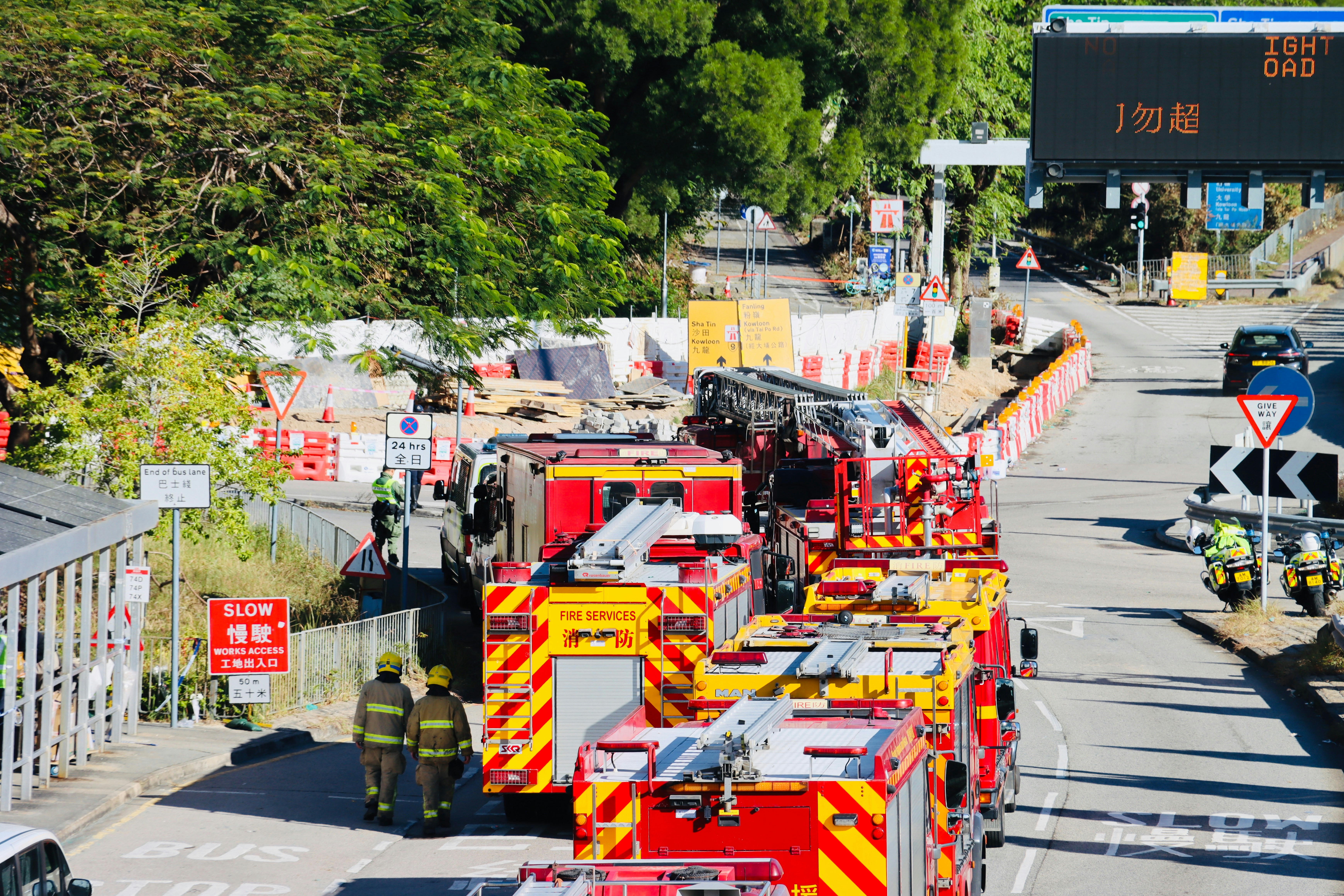 Fire trucks and emergency personnel at a construction site.