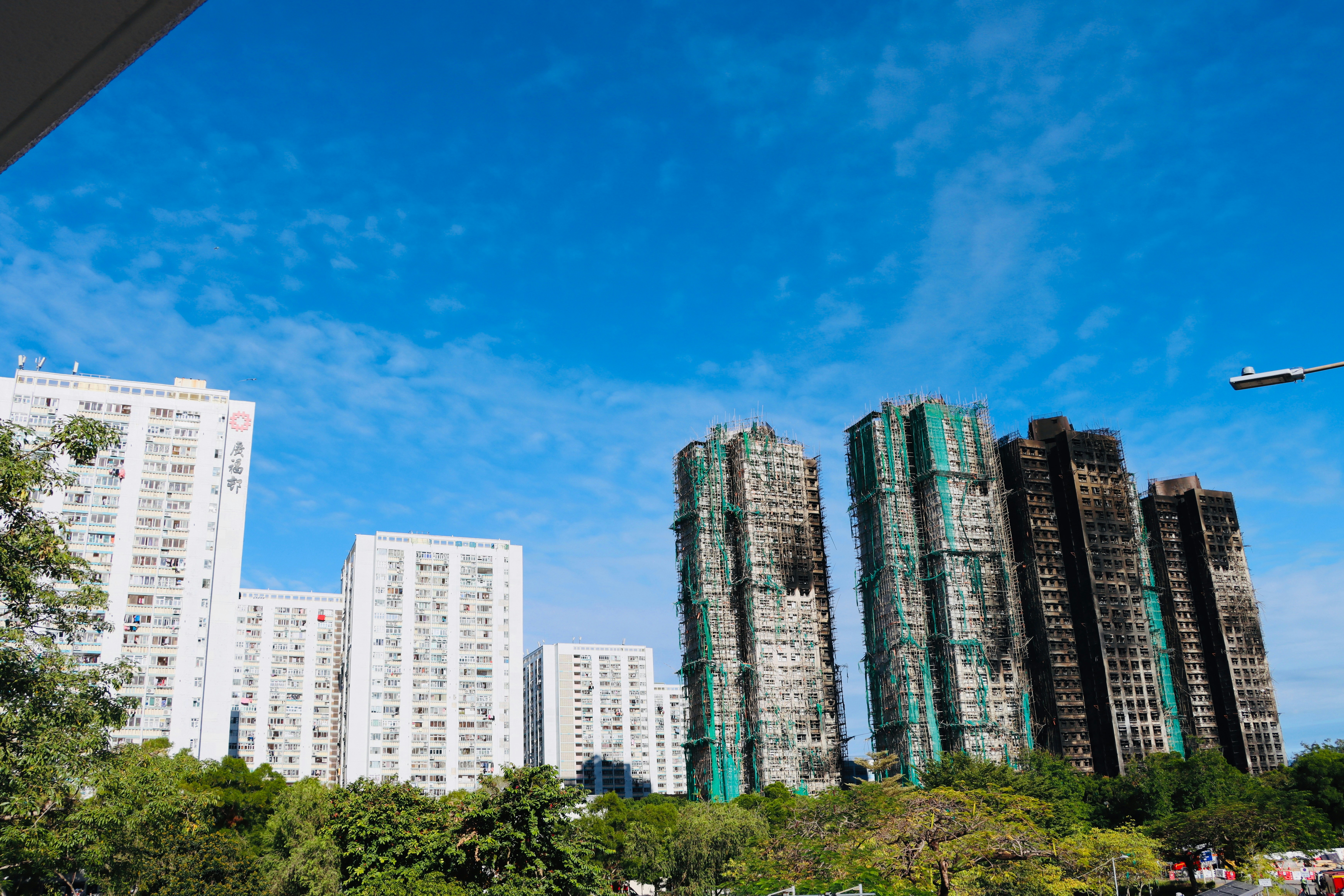 Modern high-rise buildings under a clear blue sky.