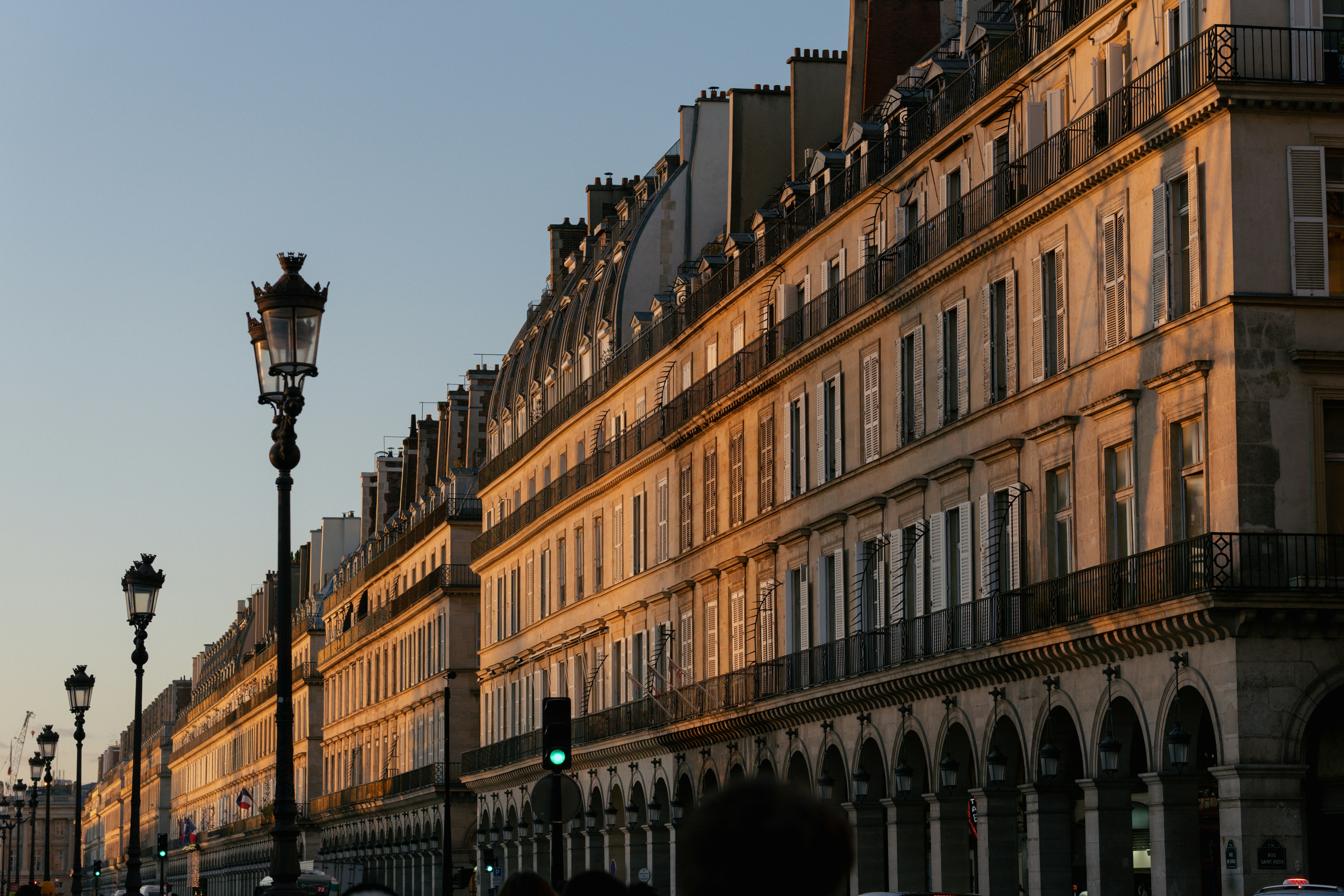 Parisian buildings illuminated by golden hour sunlight.