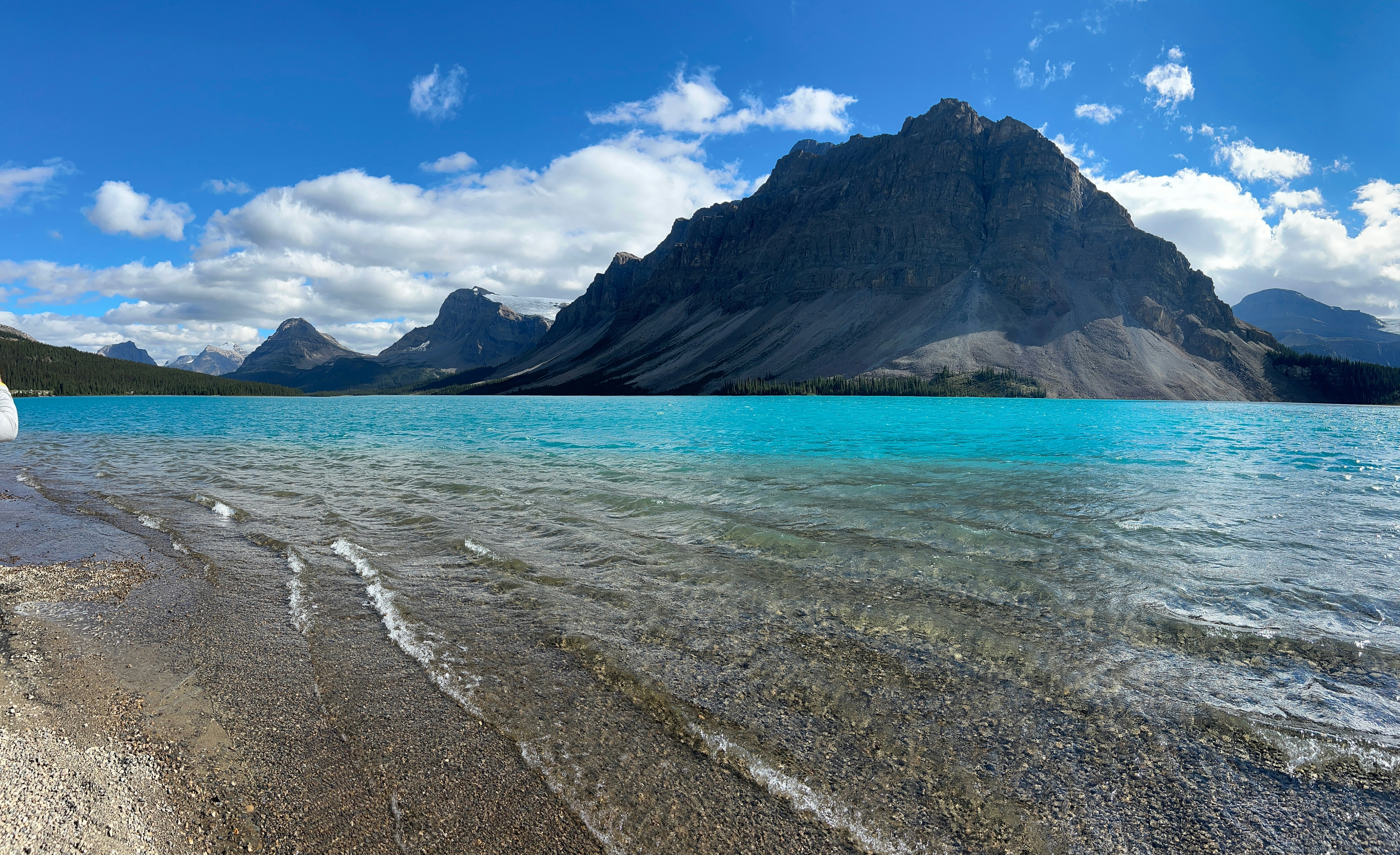 Turquoise lake with rocky mountain under blue sky
