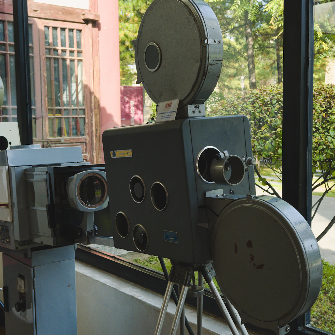 A vintage film projector and camera on display