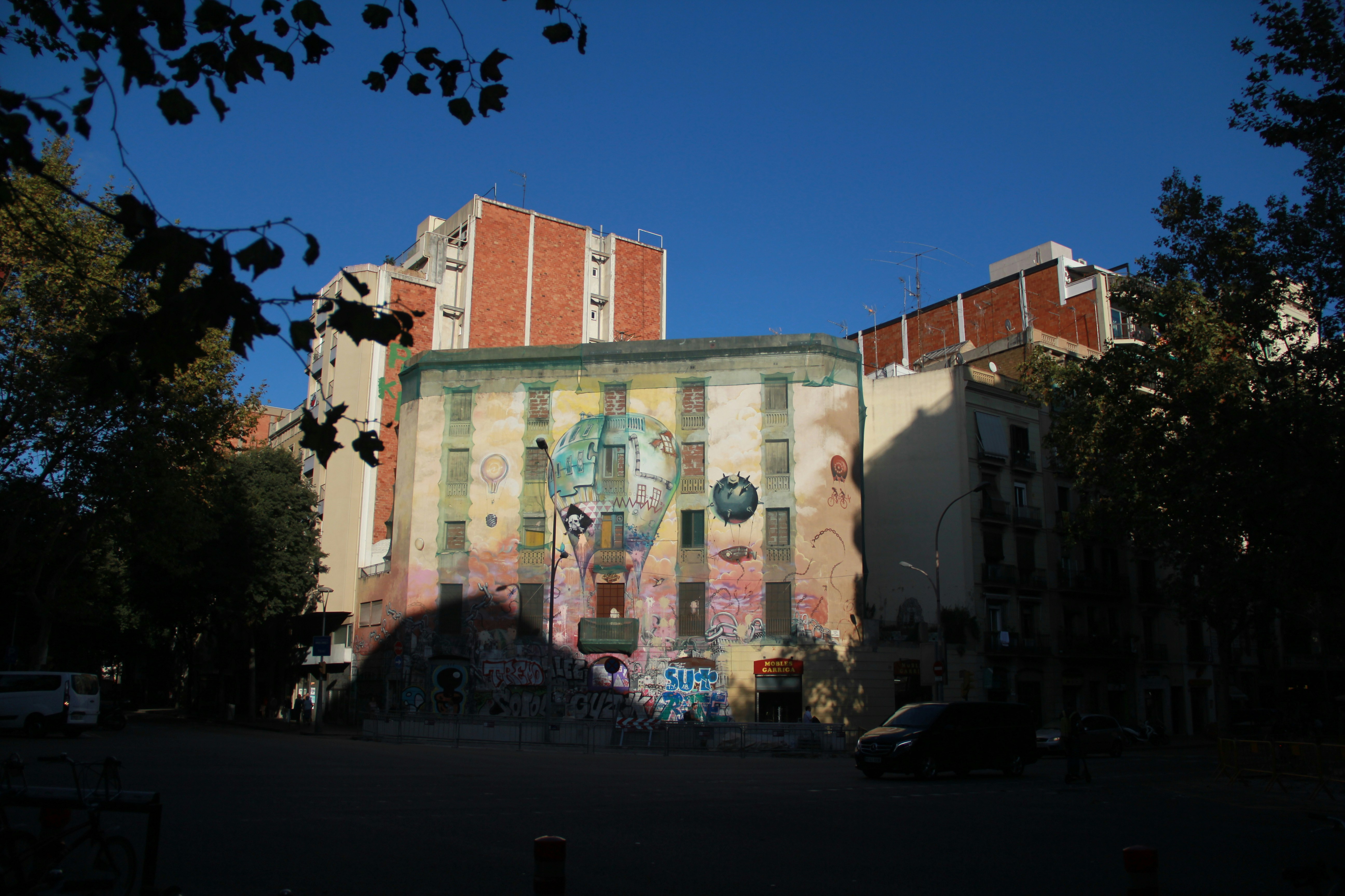 Graffiti art covers a building with a large mural.