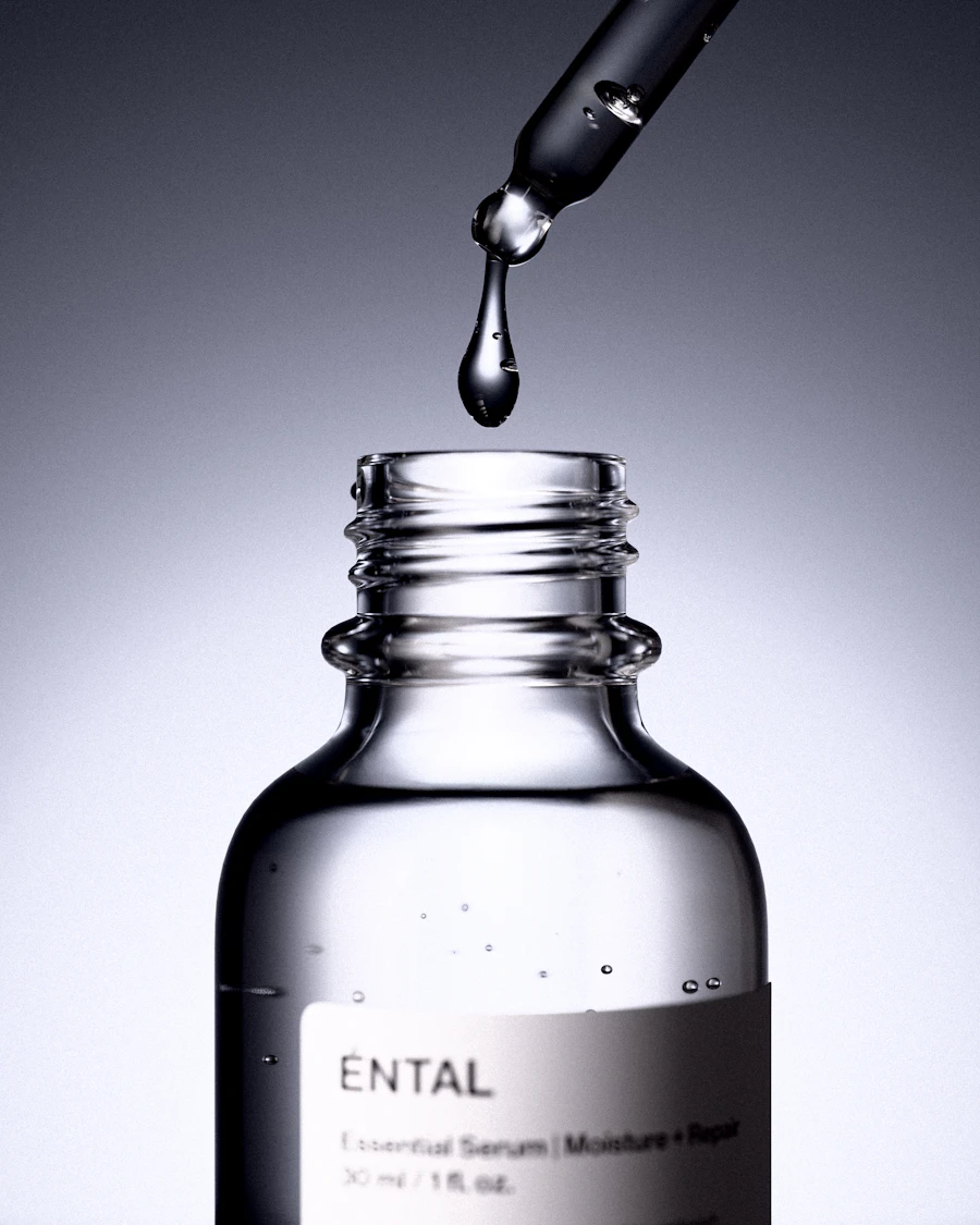 Close-up of a serum dropper over a glass bottle
