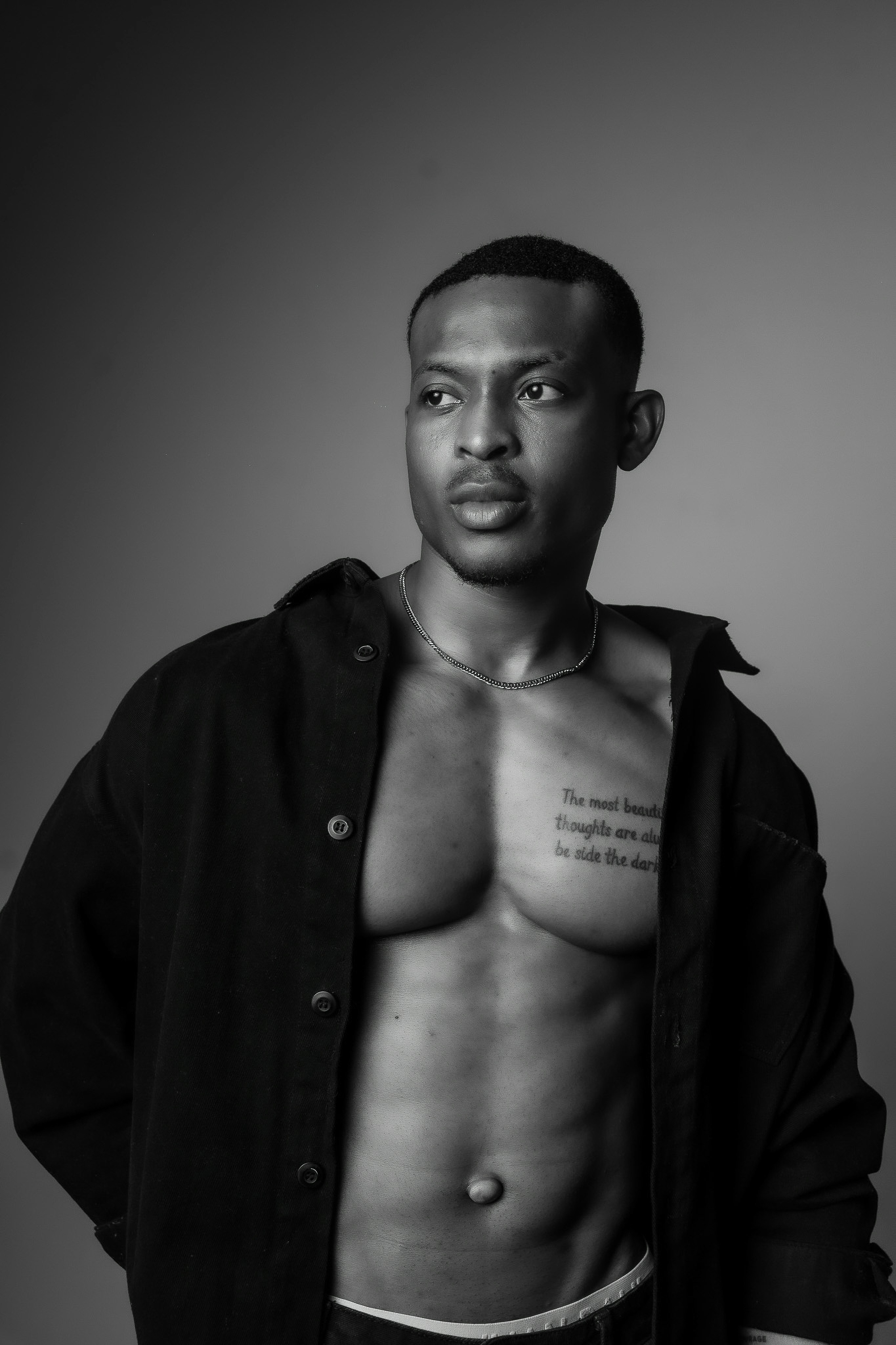 A muscular man with tattoos on his chest