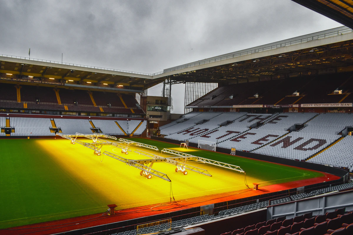 An empty floodlit football stadium and pitch at night, representing the World Cup 2026 stage that Curacao and Haiti reached