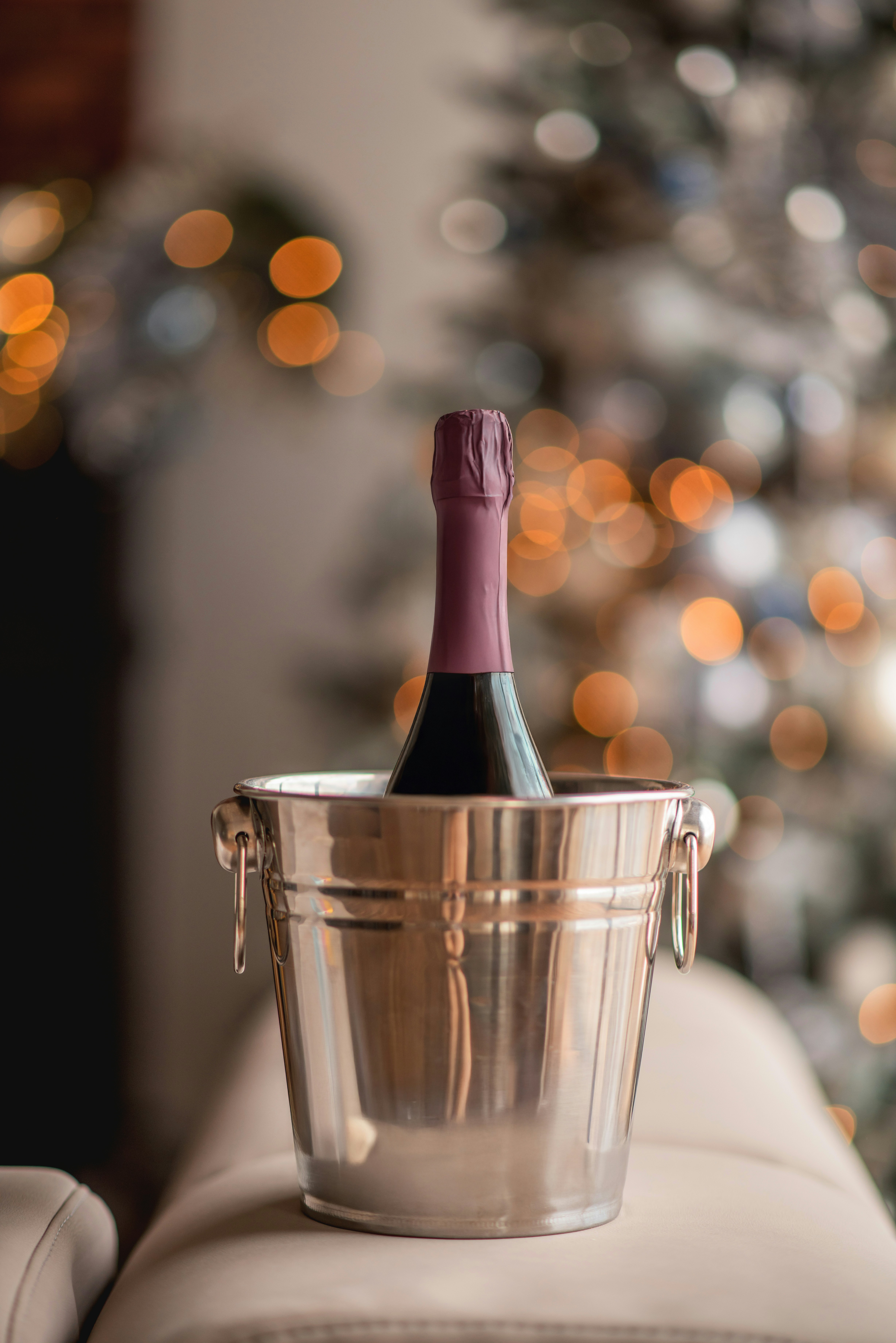 Bottle of wine in a silver bucket with bokeh lights