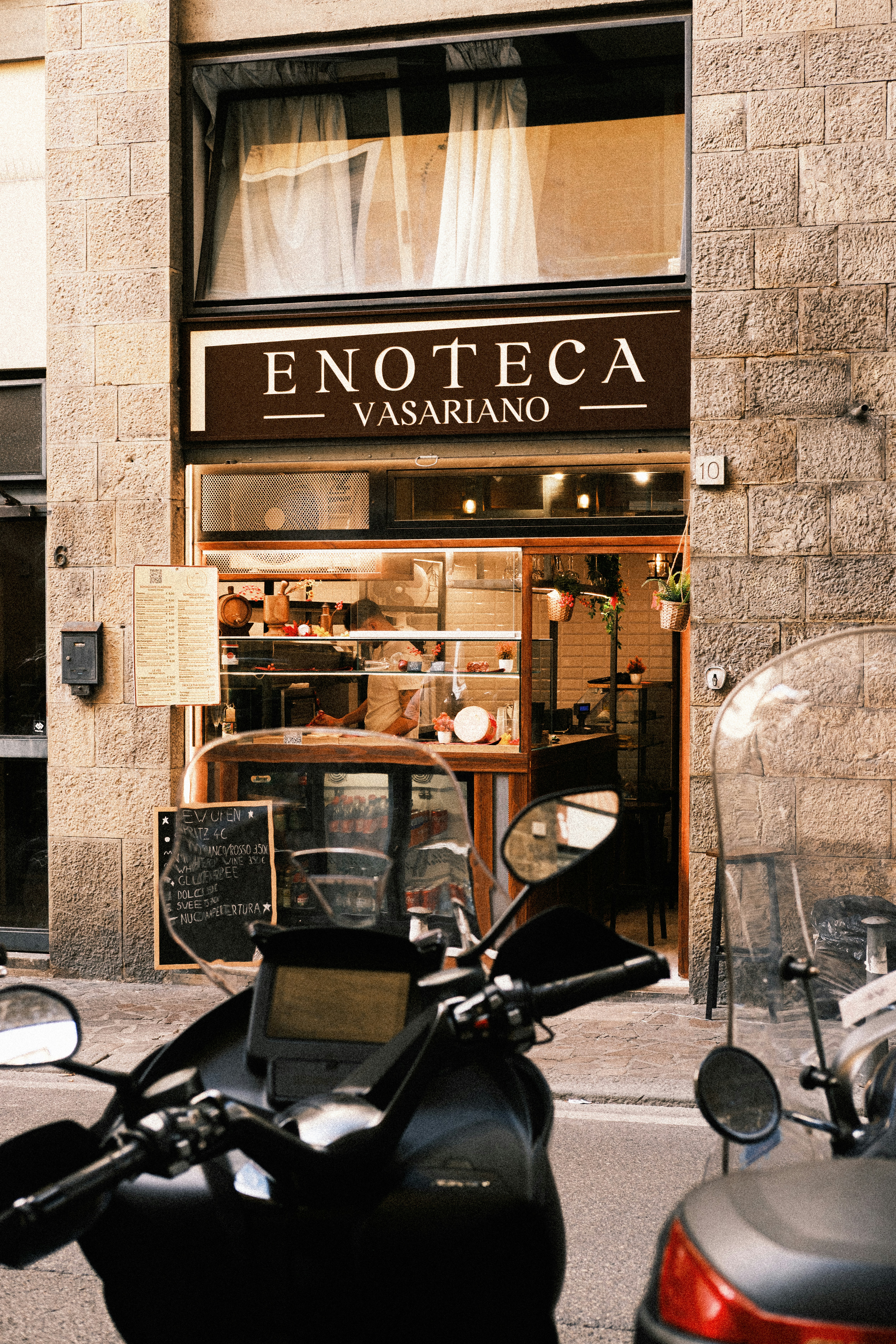 Enoteca vasariano storefront with parked motorcycles