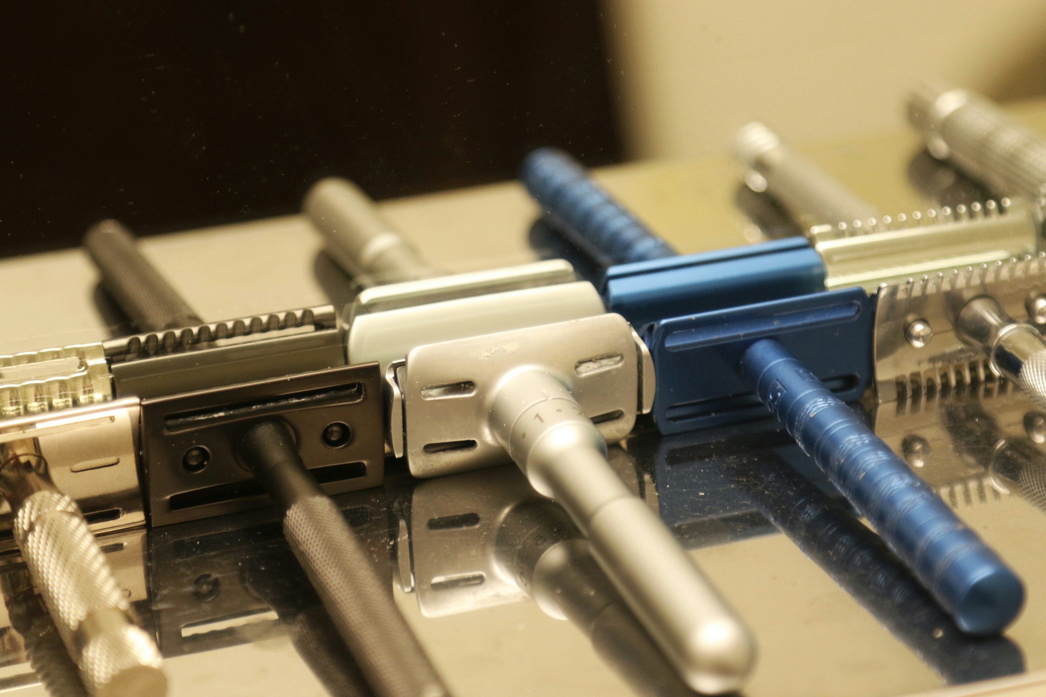 Collection of vintage safety razors arranged neatly.