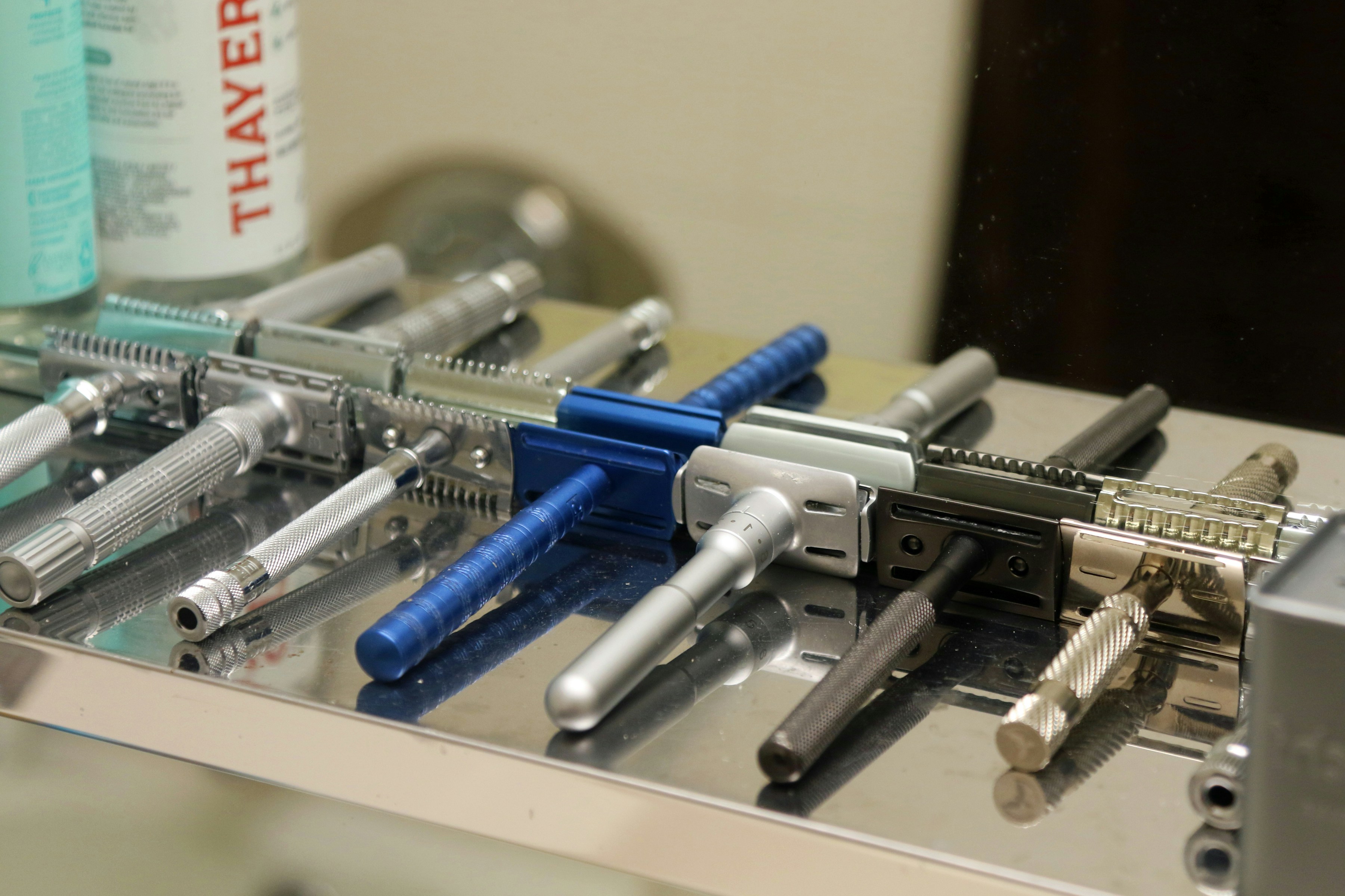 Several safety razors lined up on a shelf