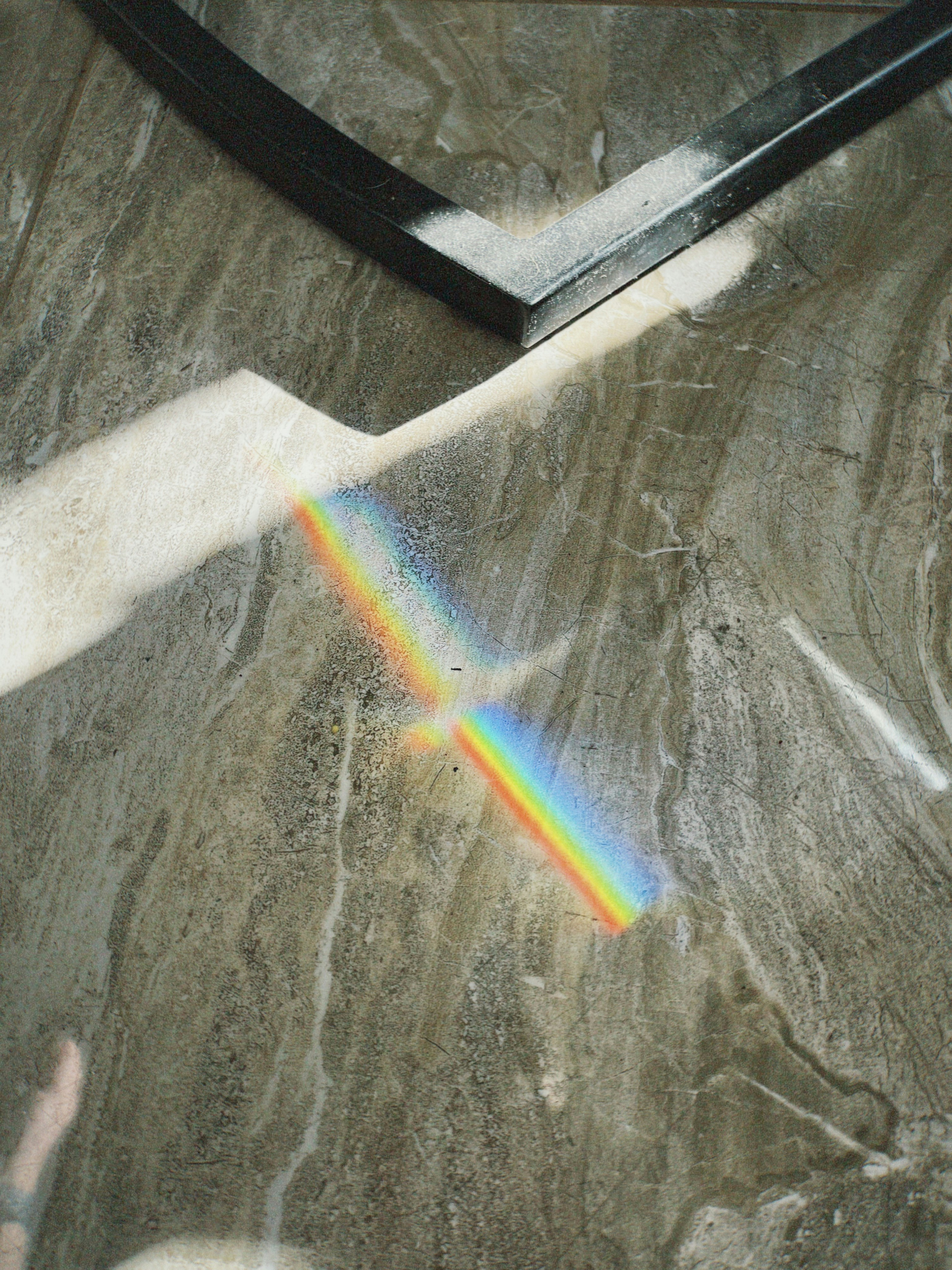 Rainbow light spectrum on marble floor