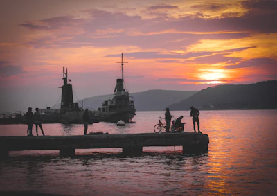 Silhouettes on a pier at sunset over the Dardanelles at Çanakkale
