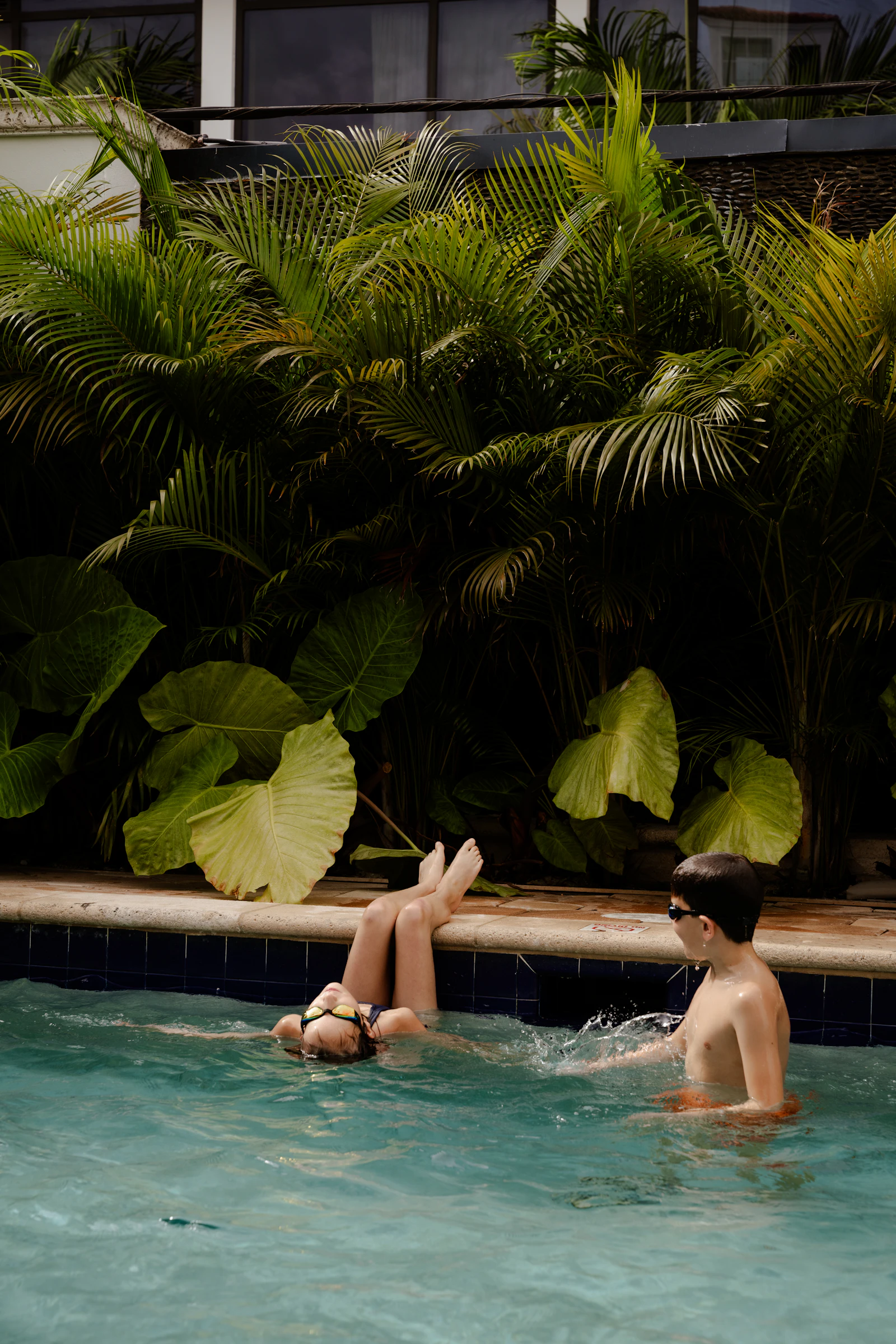 A family laughing together in the private pool on a warm Orlando afternoon