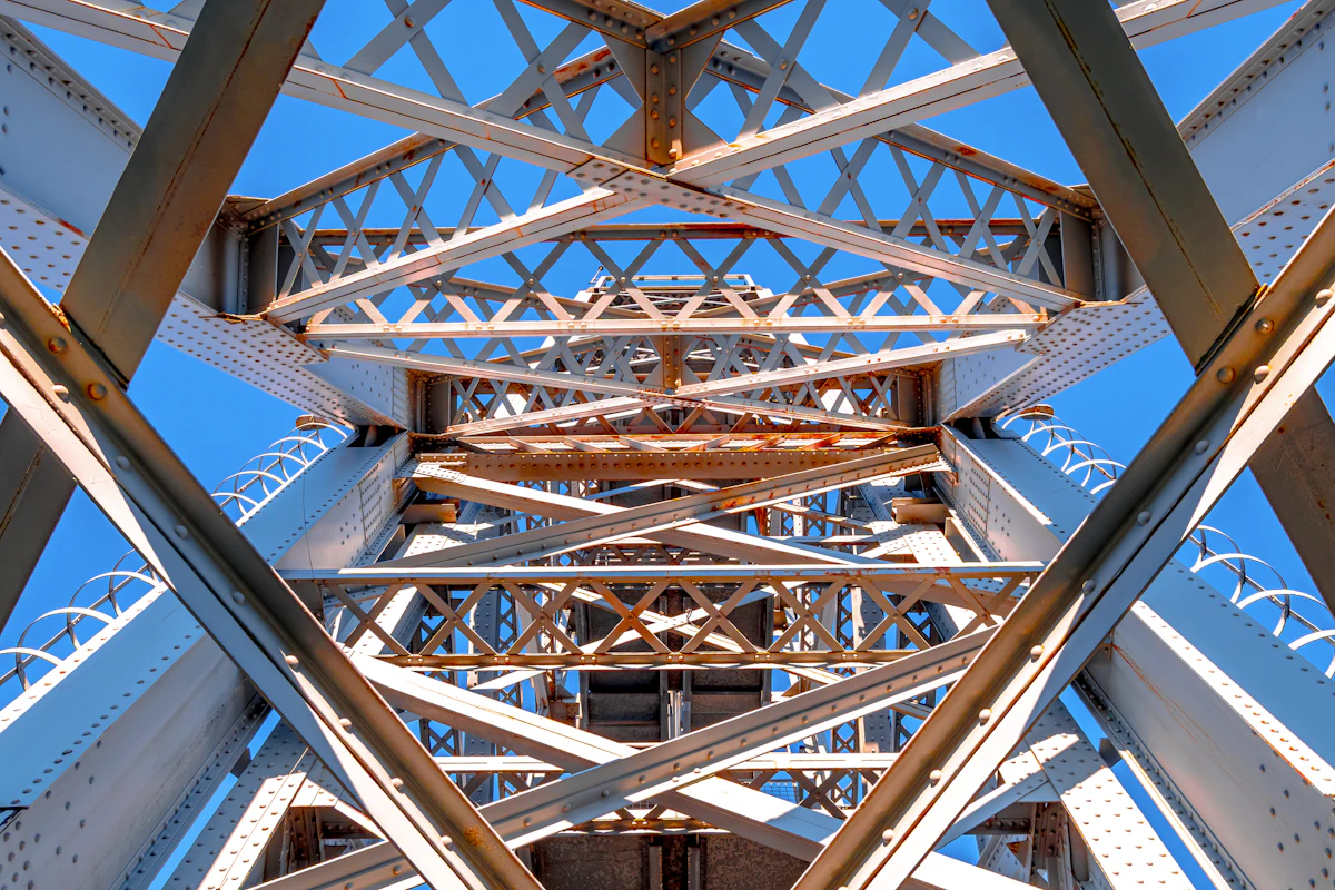 Abstract view of a steel bridge structure against blue sky