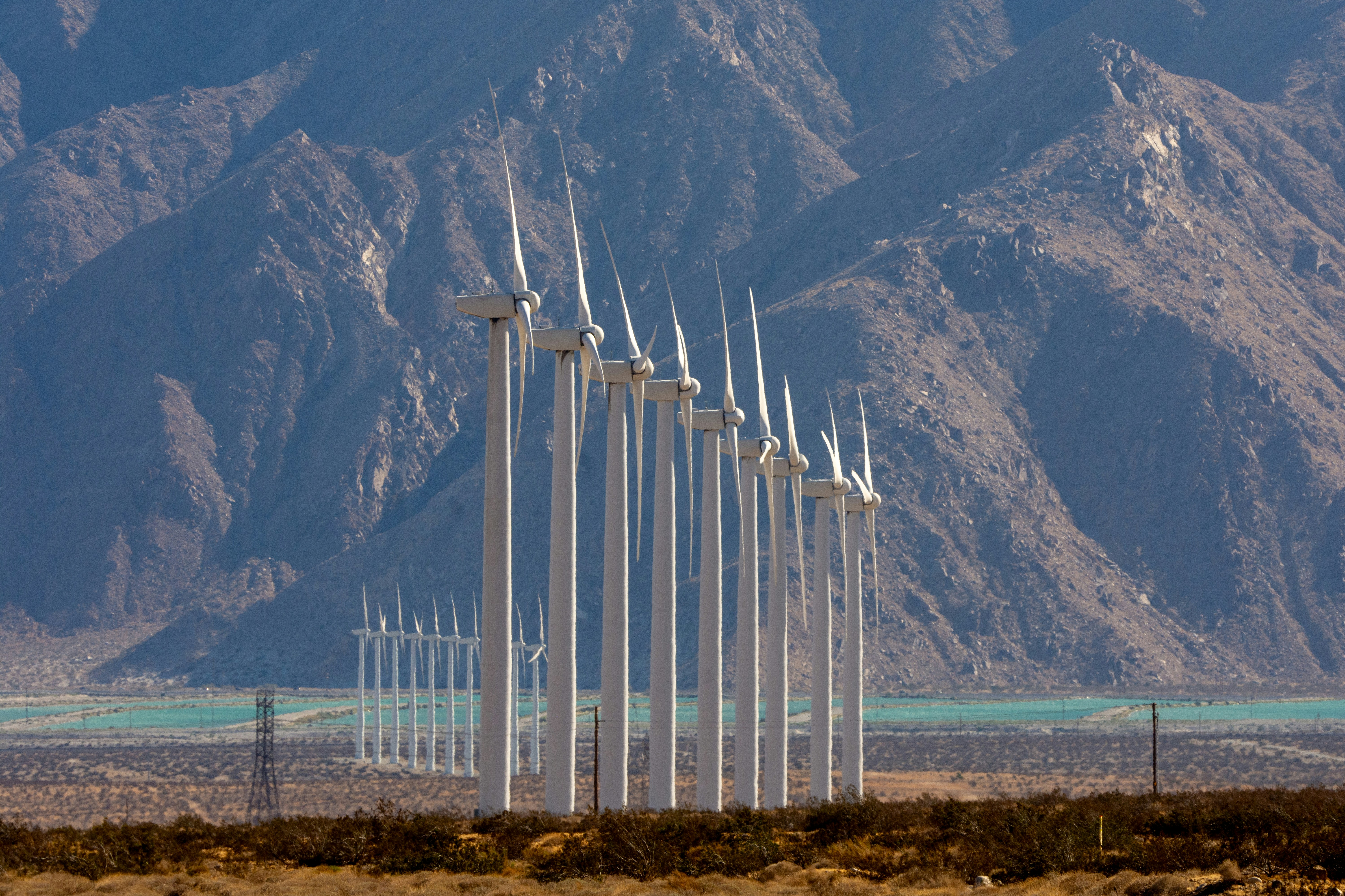 Wind turbines against mountains