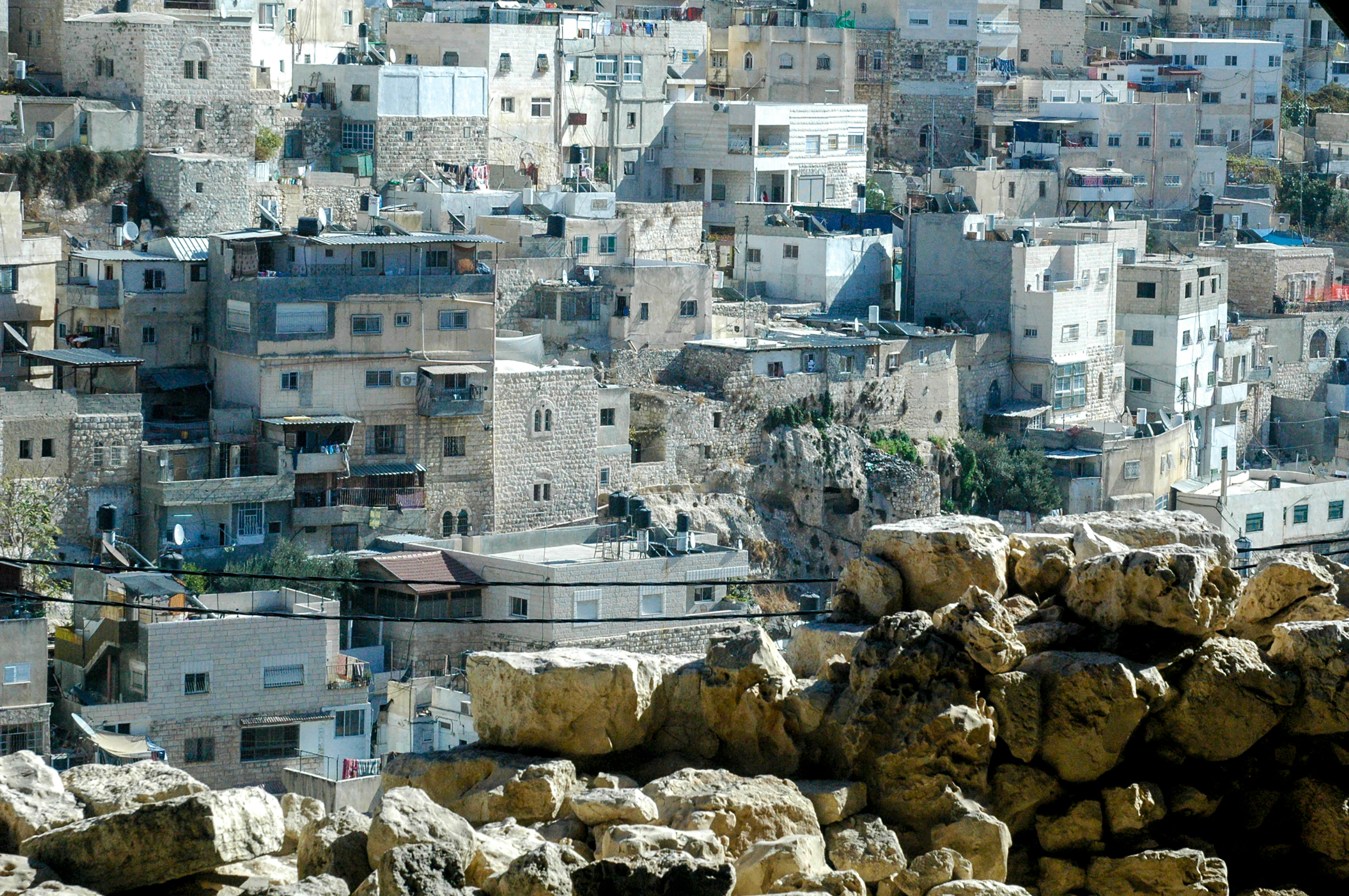 A densely packed city with stone buildings on a hill.
