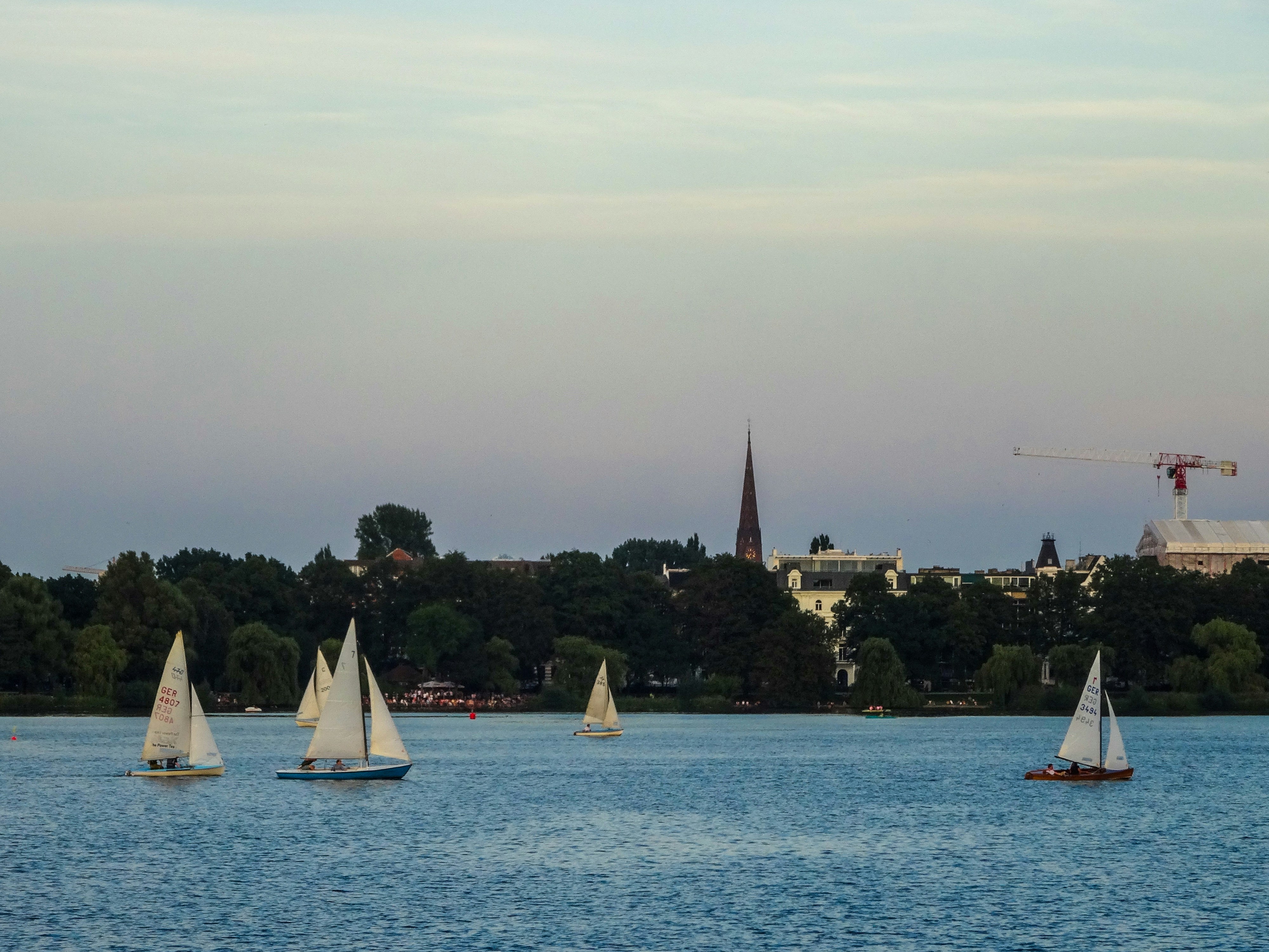 small group sailing past the city skyline, sails up, golden hour - unique San Diego activities