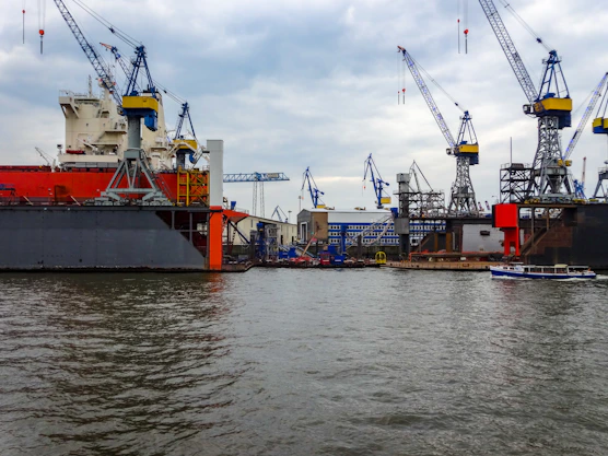 Shipyard with large cranes and docked vessels
