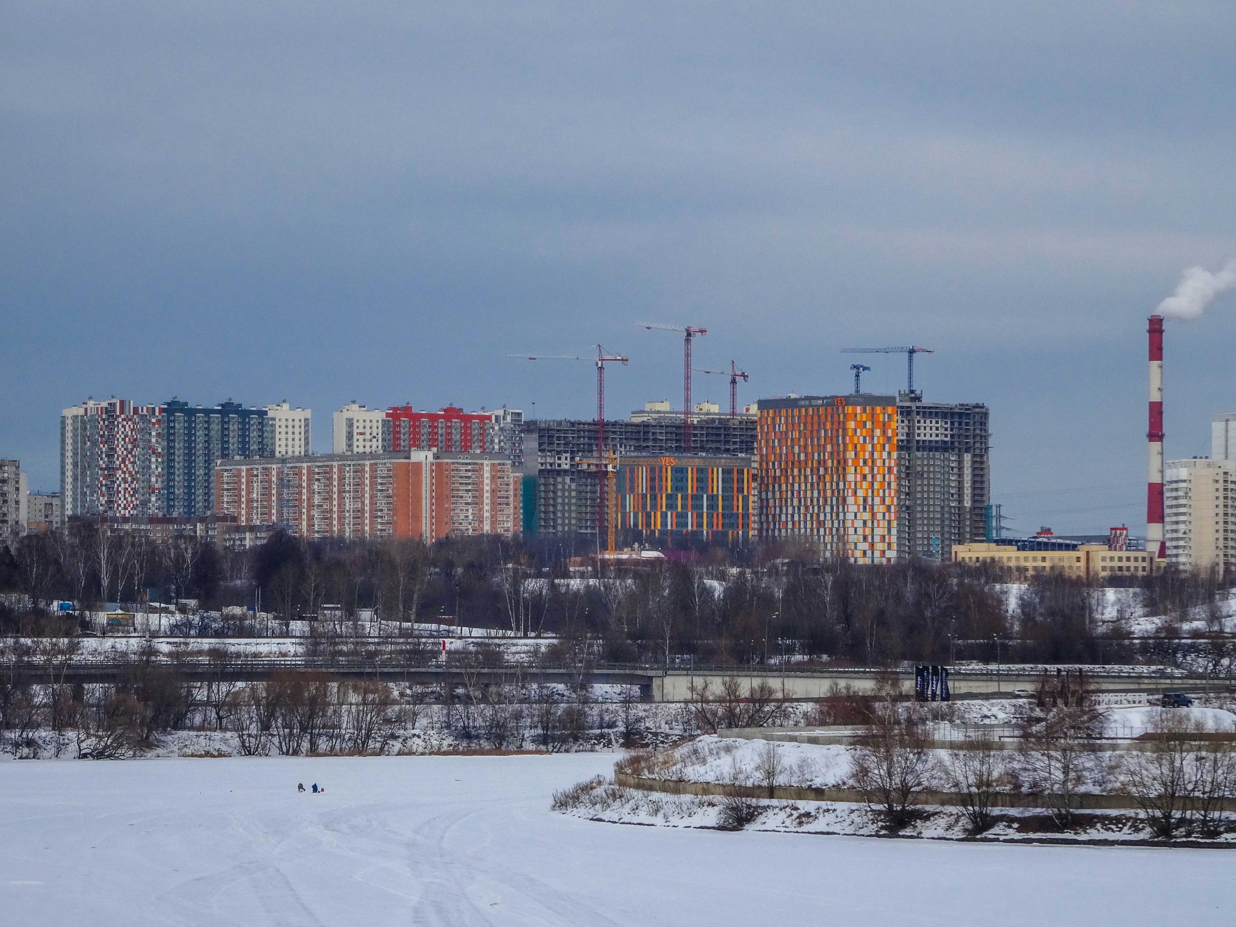 Modern apartment buildings under construction by river