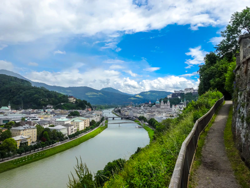 The Salzach river curving through Salzburg below green hills