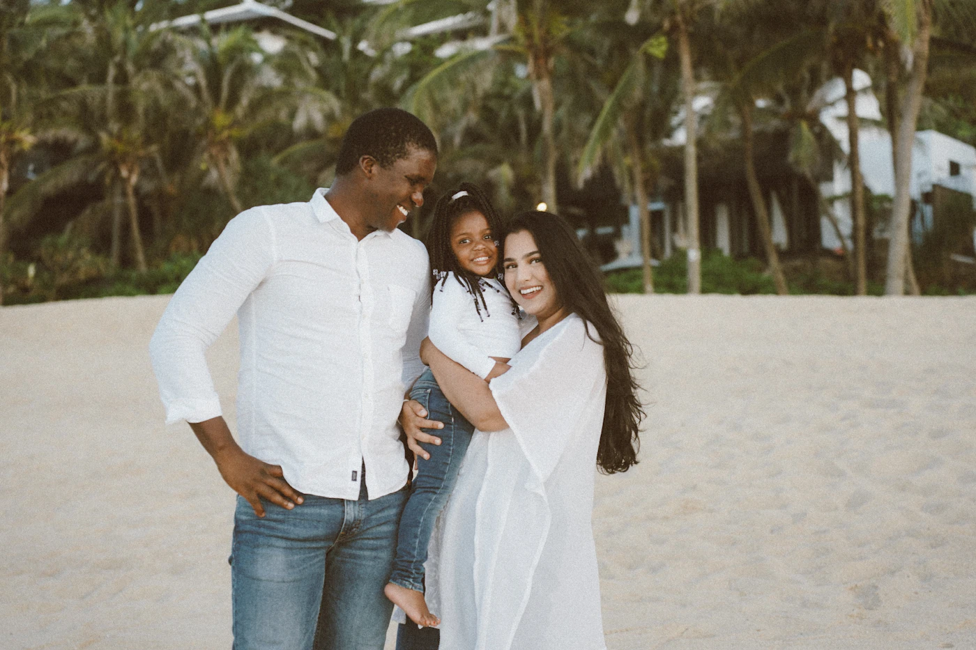 A happy Black family posing on a sunny beach