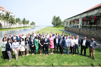 A diverse group of people posing for a photo outdoors.