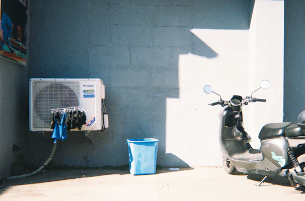 Air conditioner unit with clothes and scooter