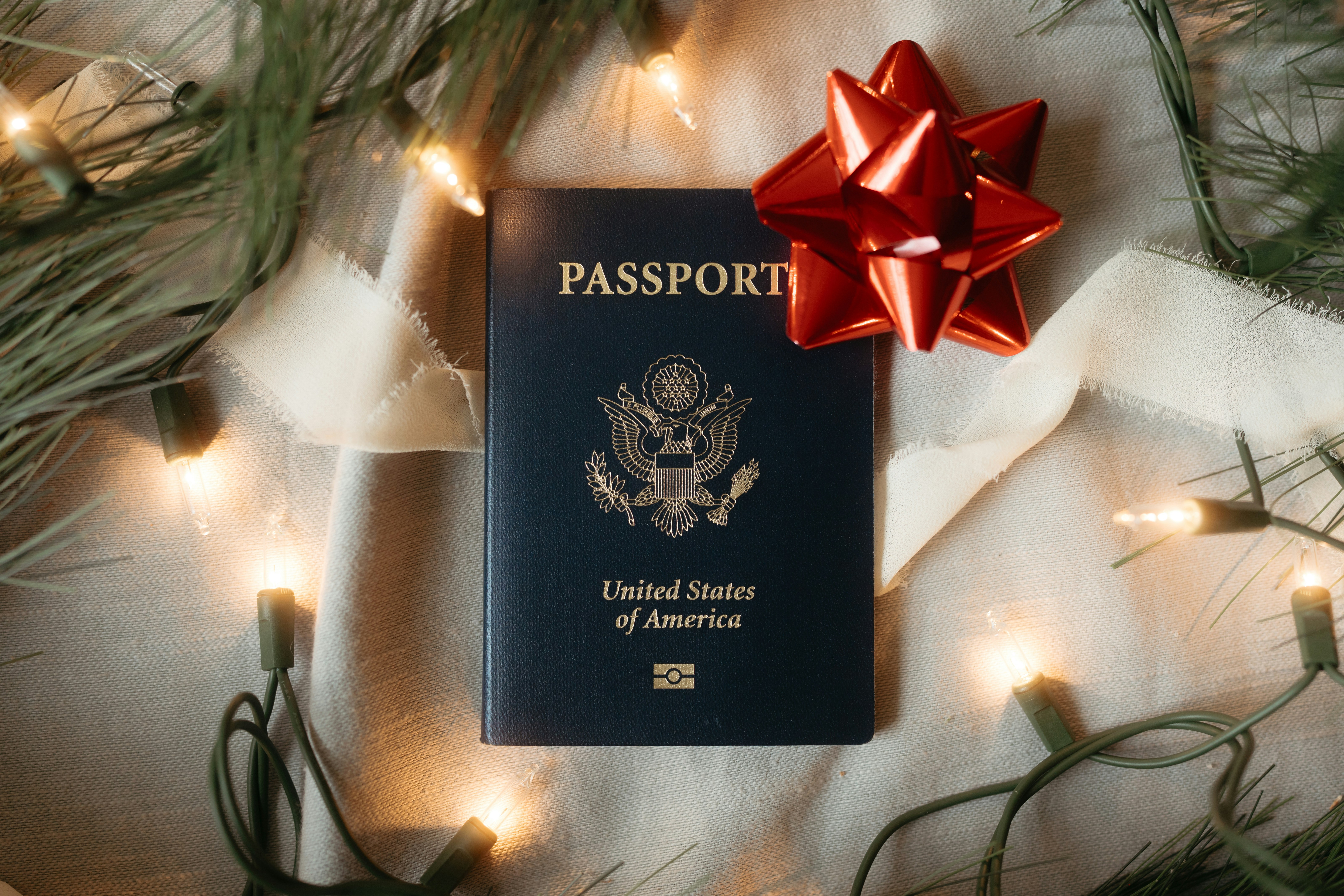 Passport decorated as a christmas gift with lights