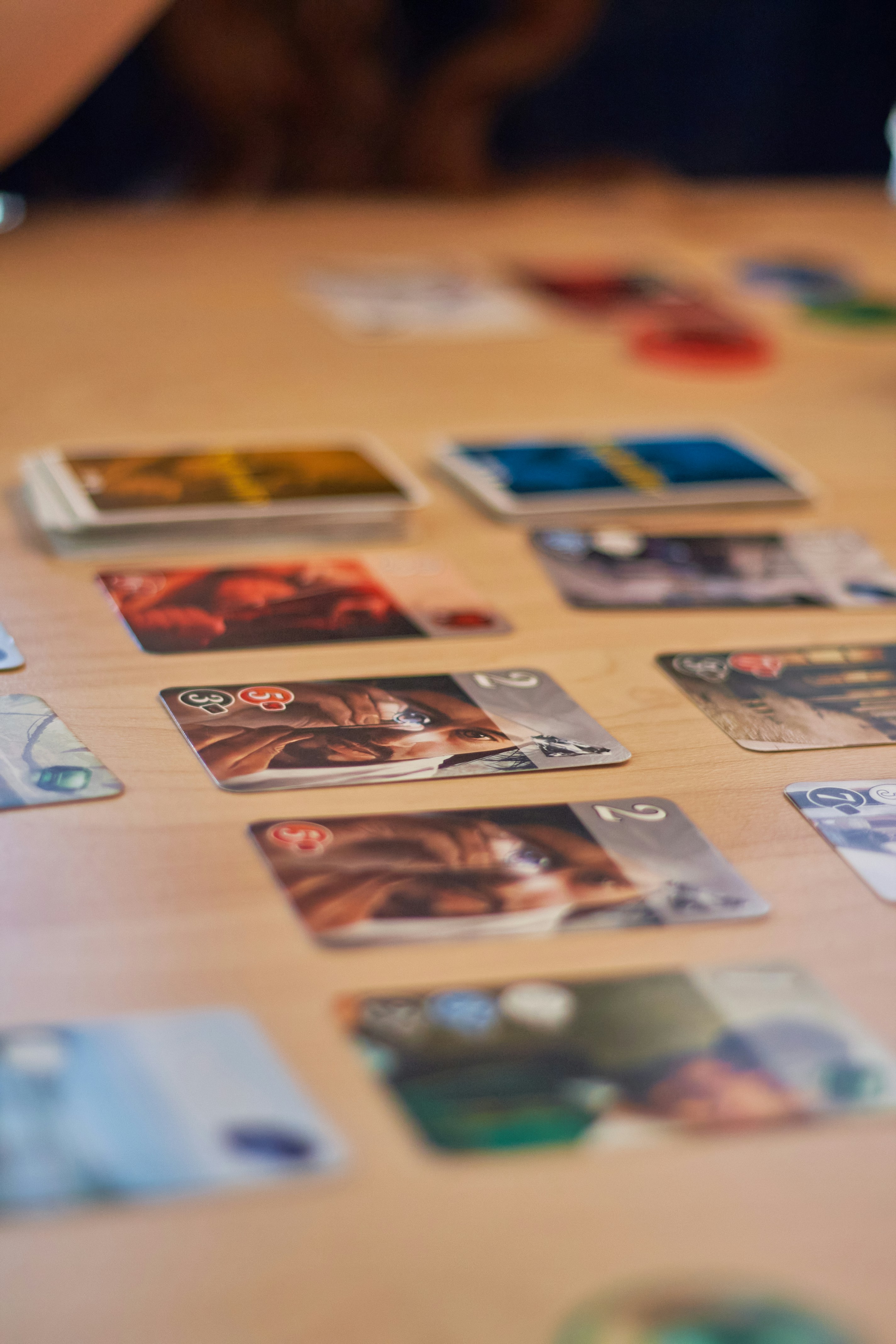 Cards are laid out on a wooden table.