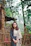 Young woman standing outdoors near a wooden fence.