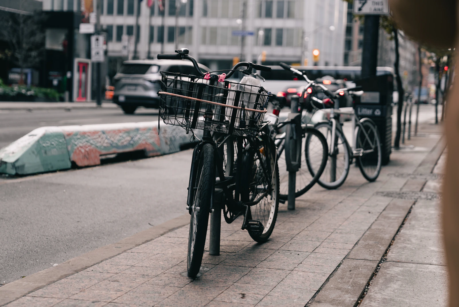 Bicycles parked along a city sidewalk.