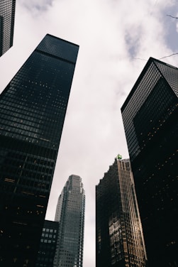 Tall modern skyscrapers against a cloudy sky.