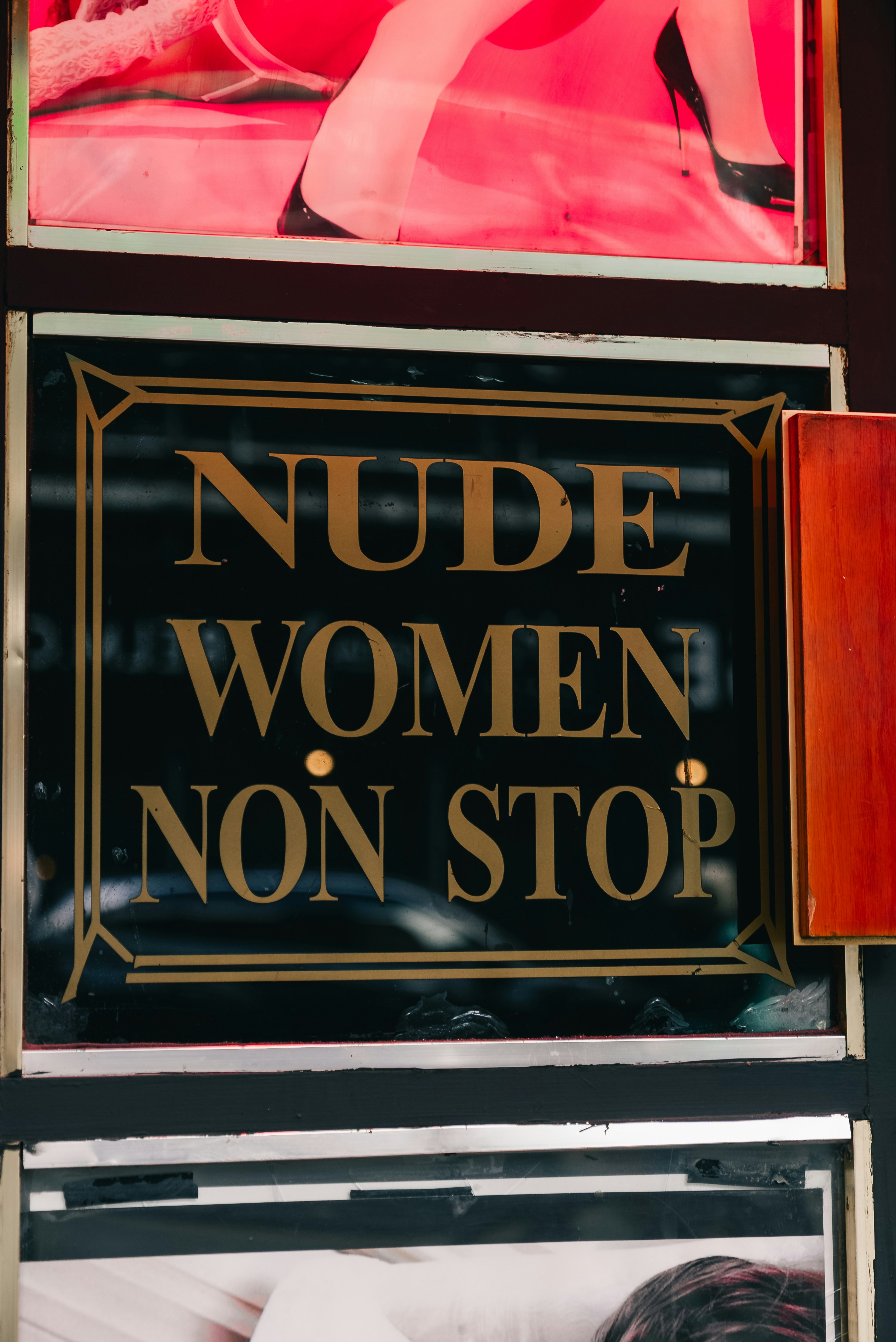 Sign reads "nude women non stop"