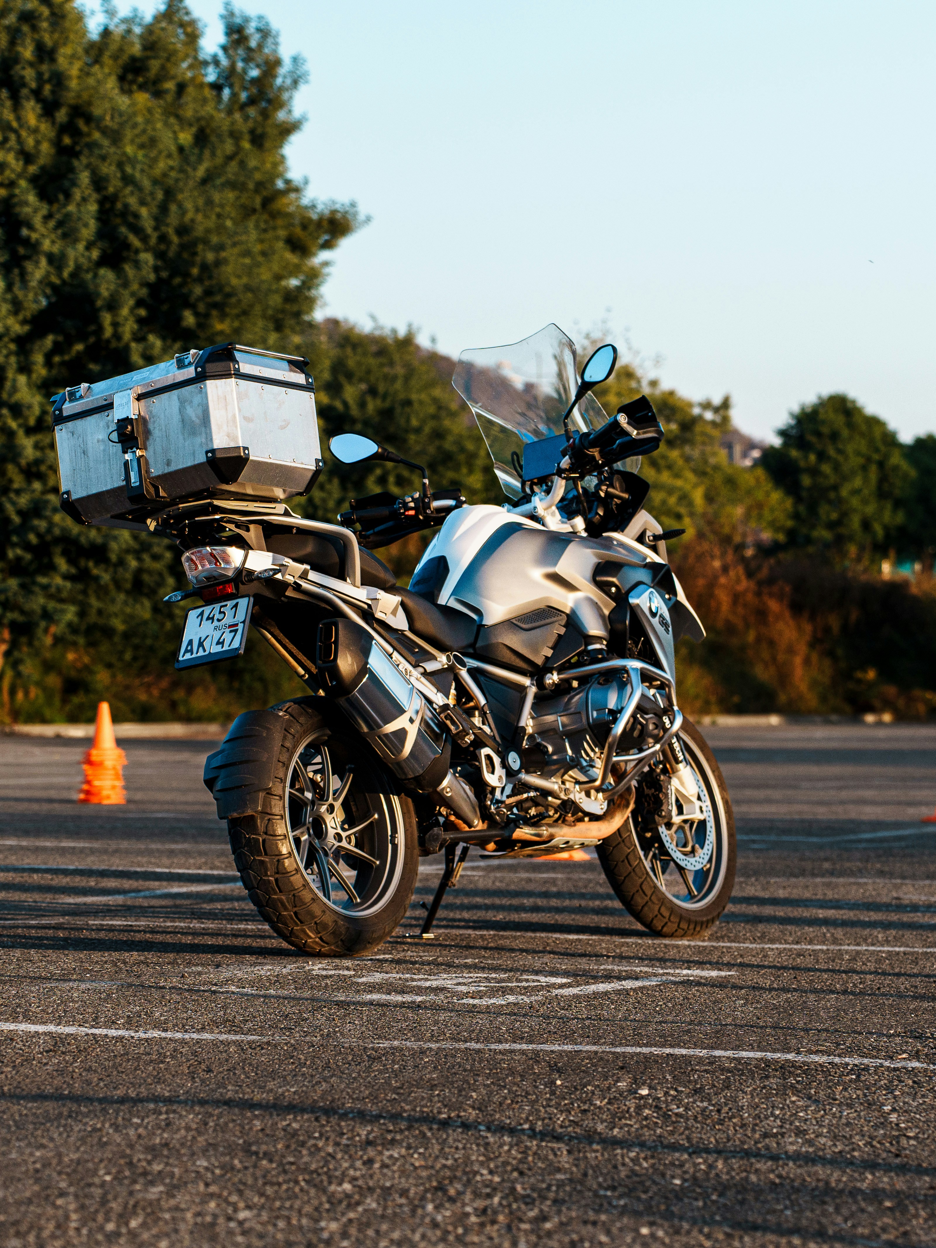 A white and silver adventure motorcycle parked outdoors.