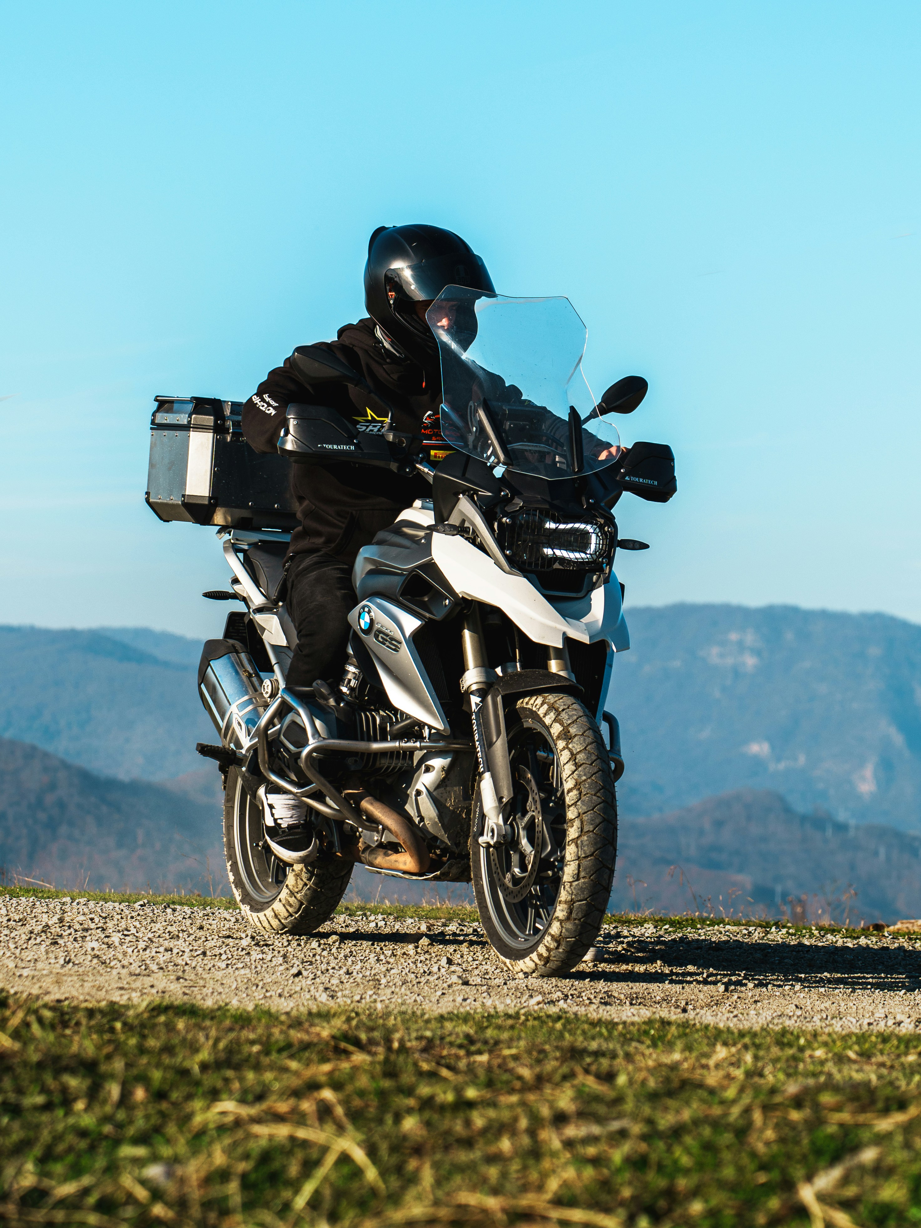 Rider on a motorcycle on a dirt road.