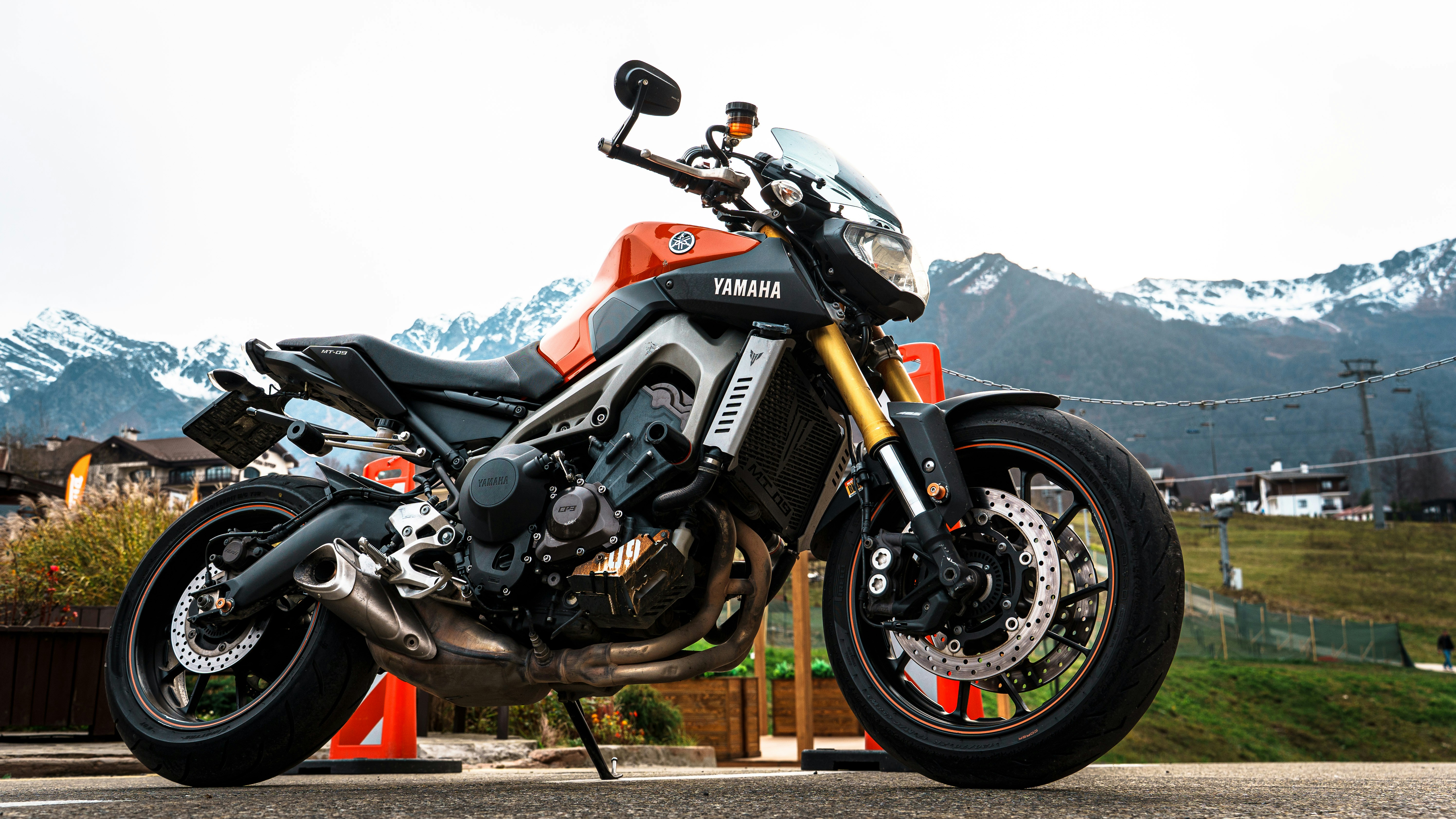Orange and black yamaha motorcycle parked outdoors.