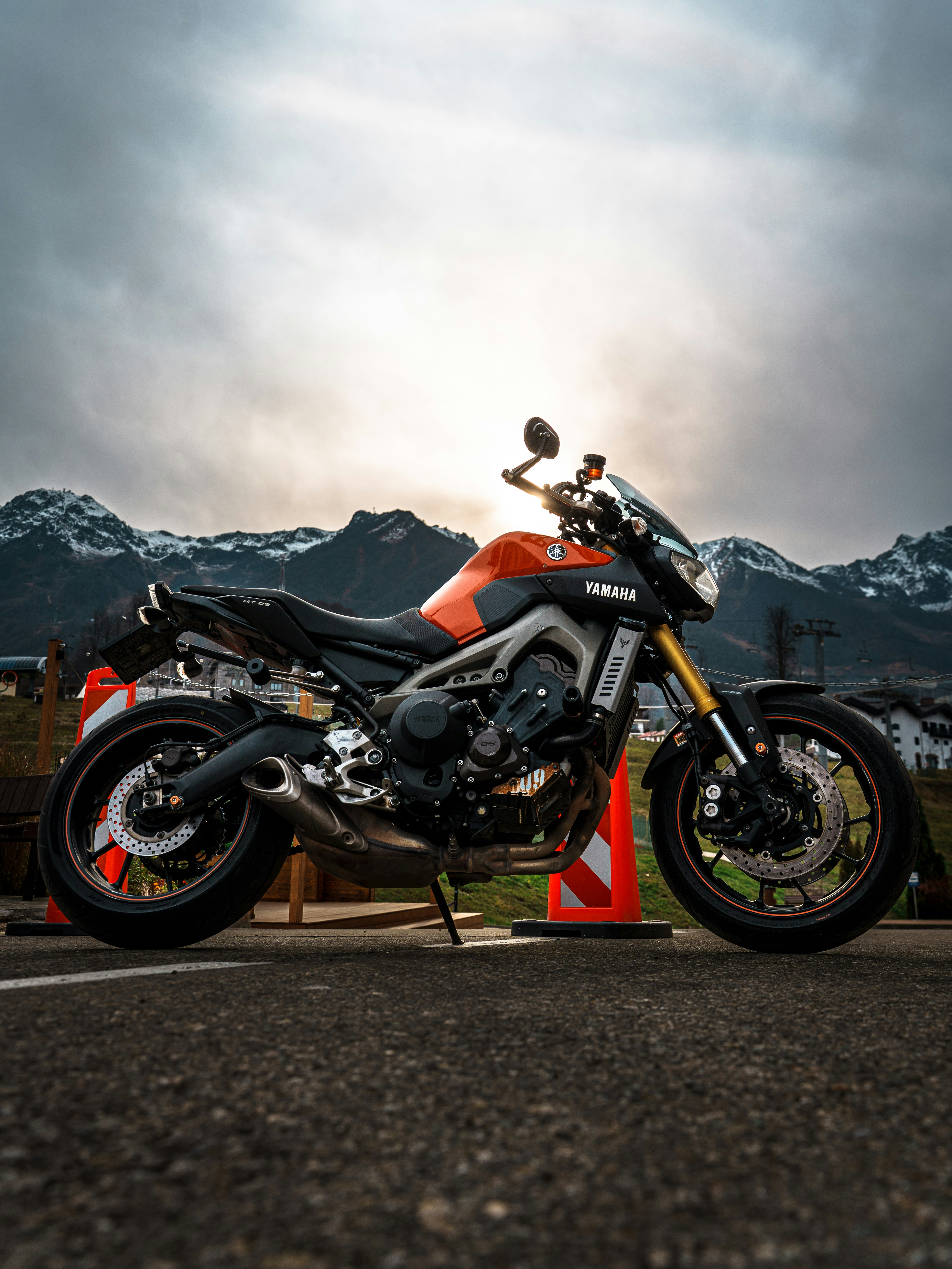 Orange and black yamaha motorcycle parked outdoors.