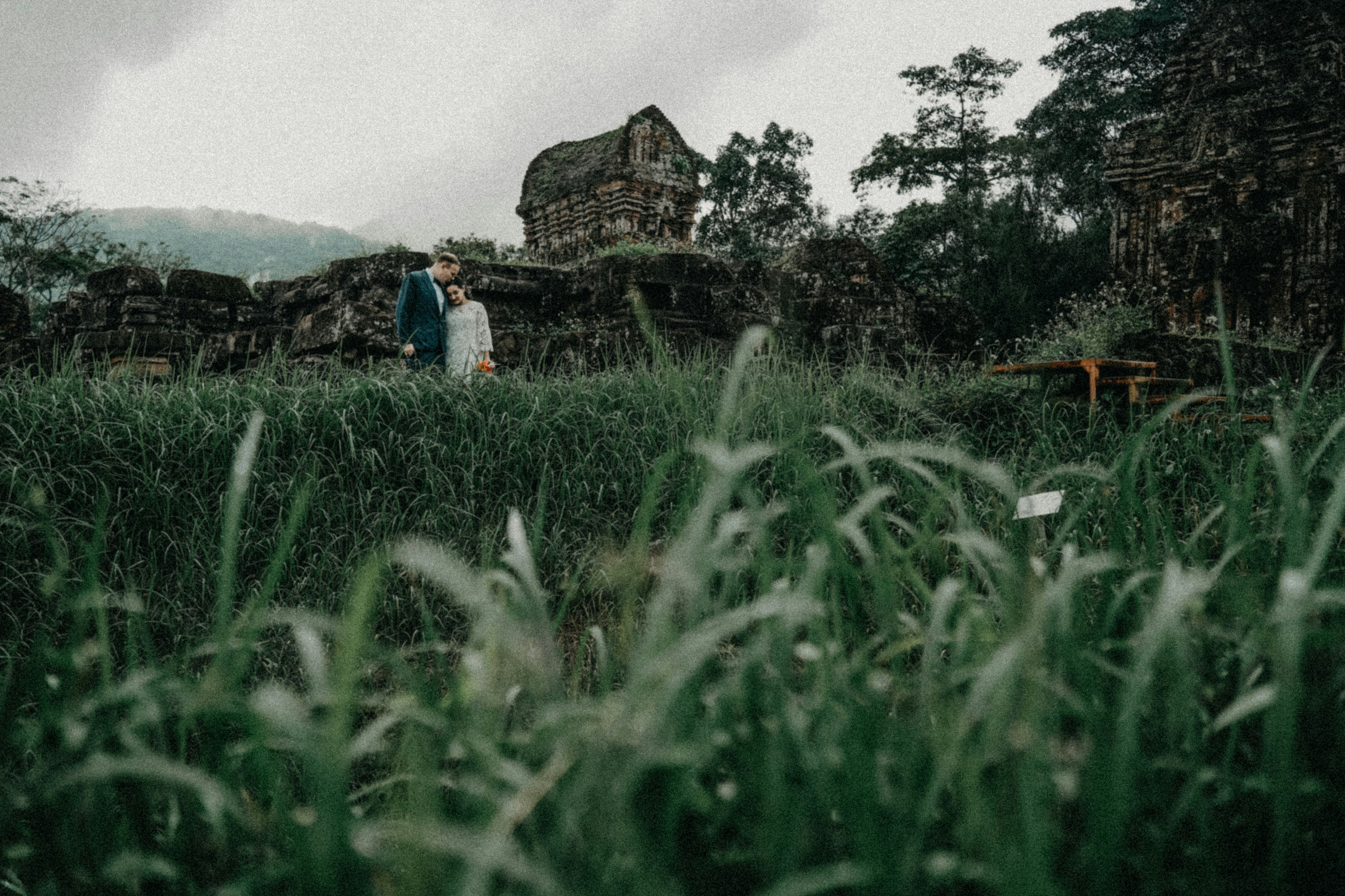 Couple standing in front of ancient stone structure