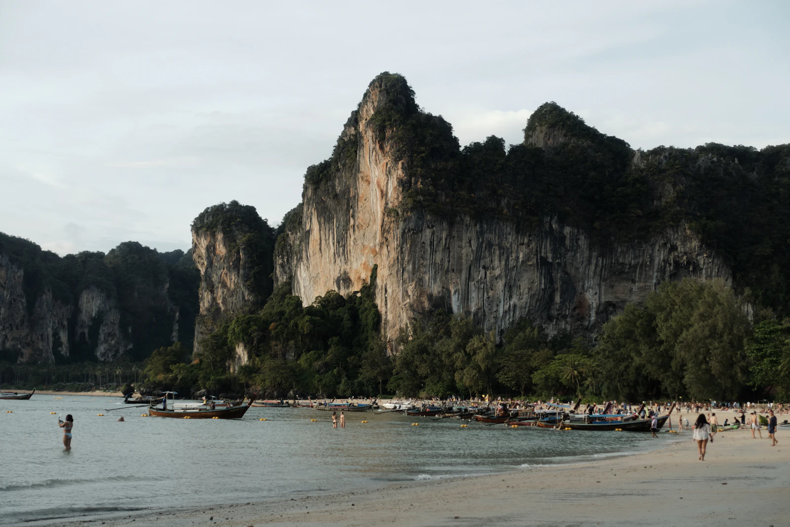 Beach with limestone cliffs and longtail boats