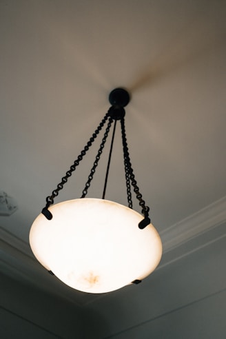 An antique chandelier hangs from a ceiling.