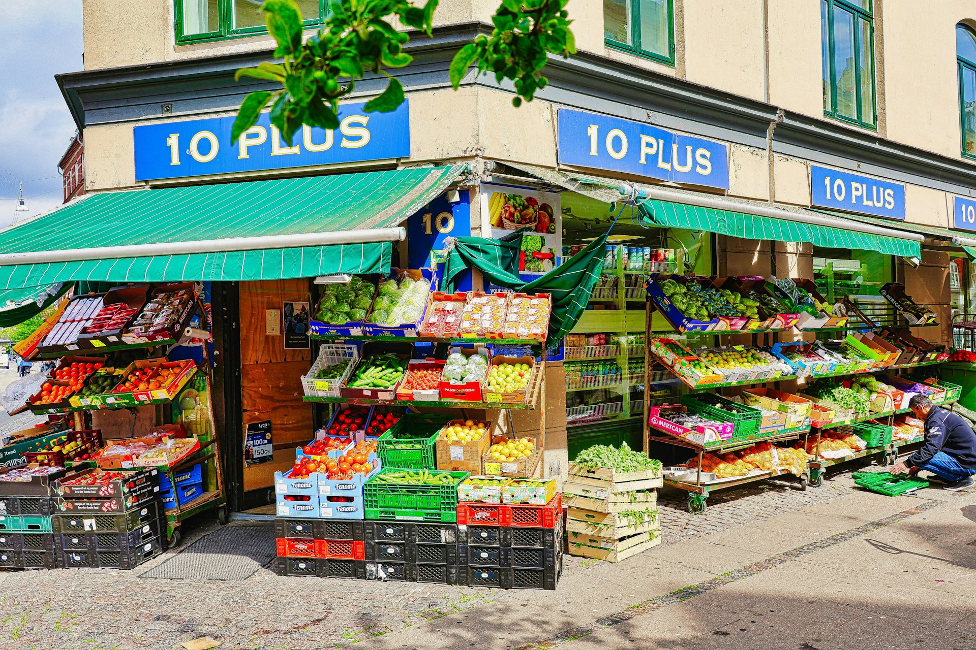 Corner store with fresh produce displayed outside.
