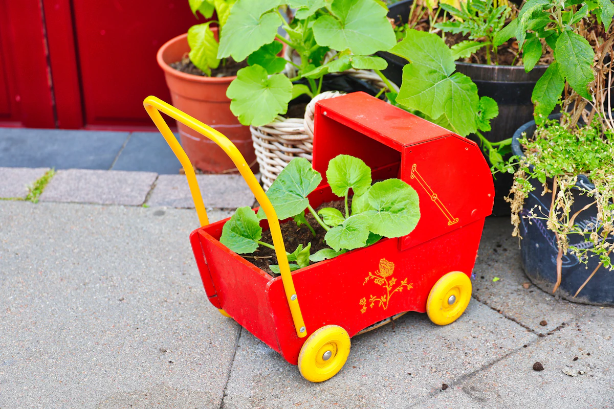 Red toy stroller used as a planter
