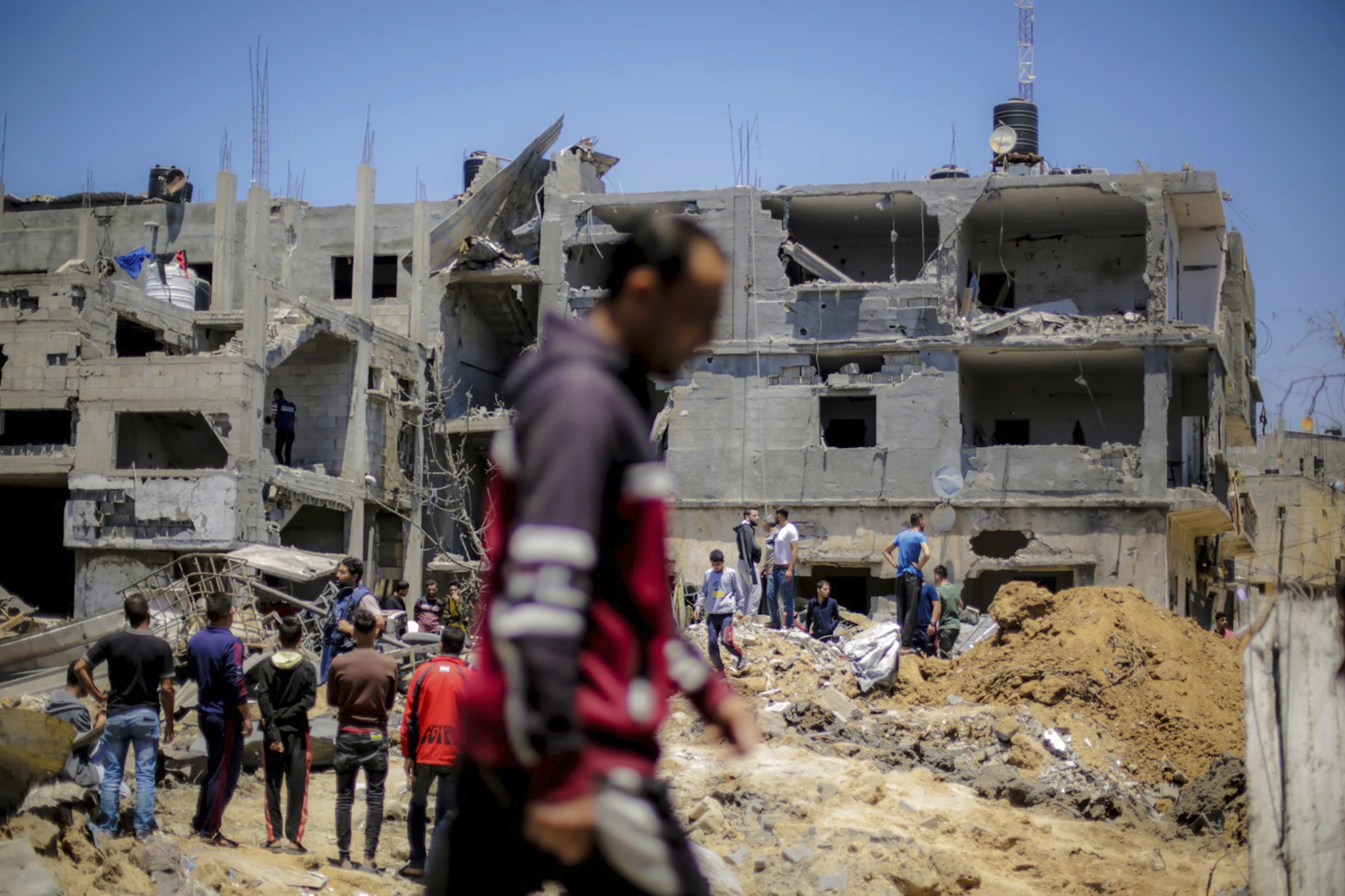 Residents of Gaza inspect the ruins of their destroyed homes