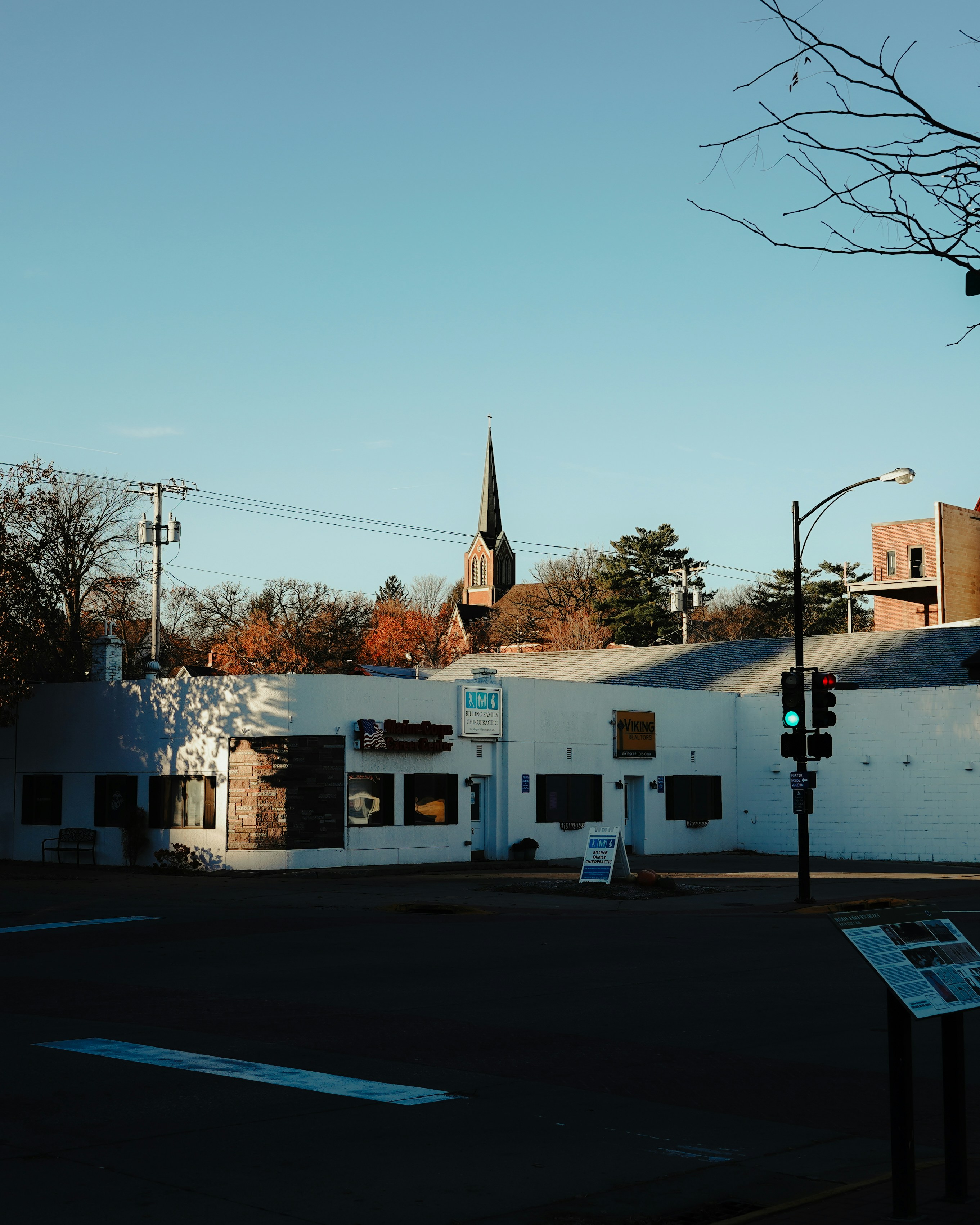 White building with church steeple in background