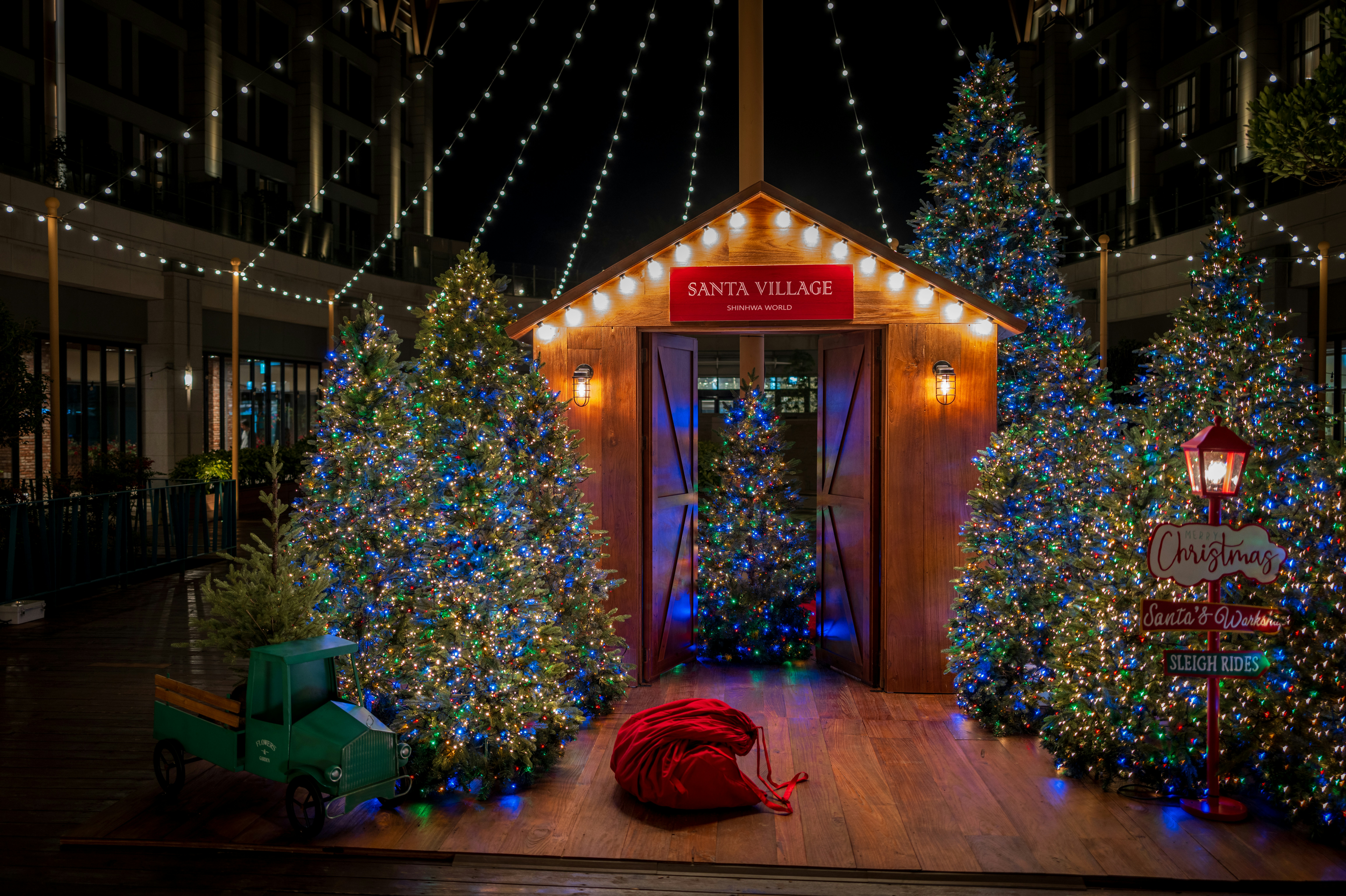 Santa village with decorated trees and lights at night