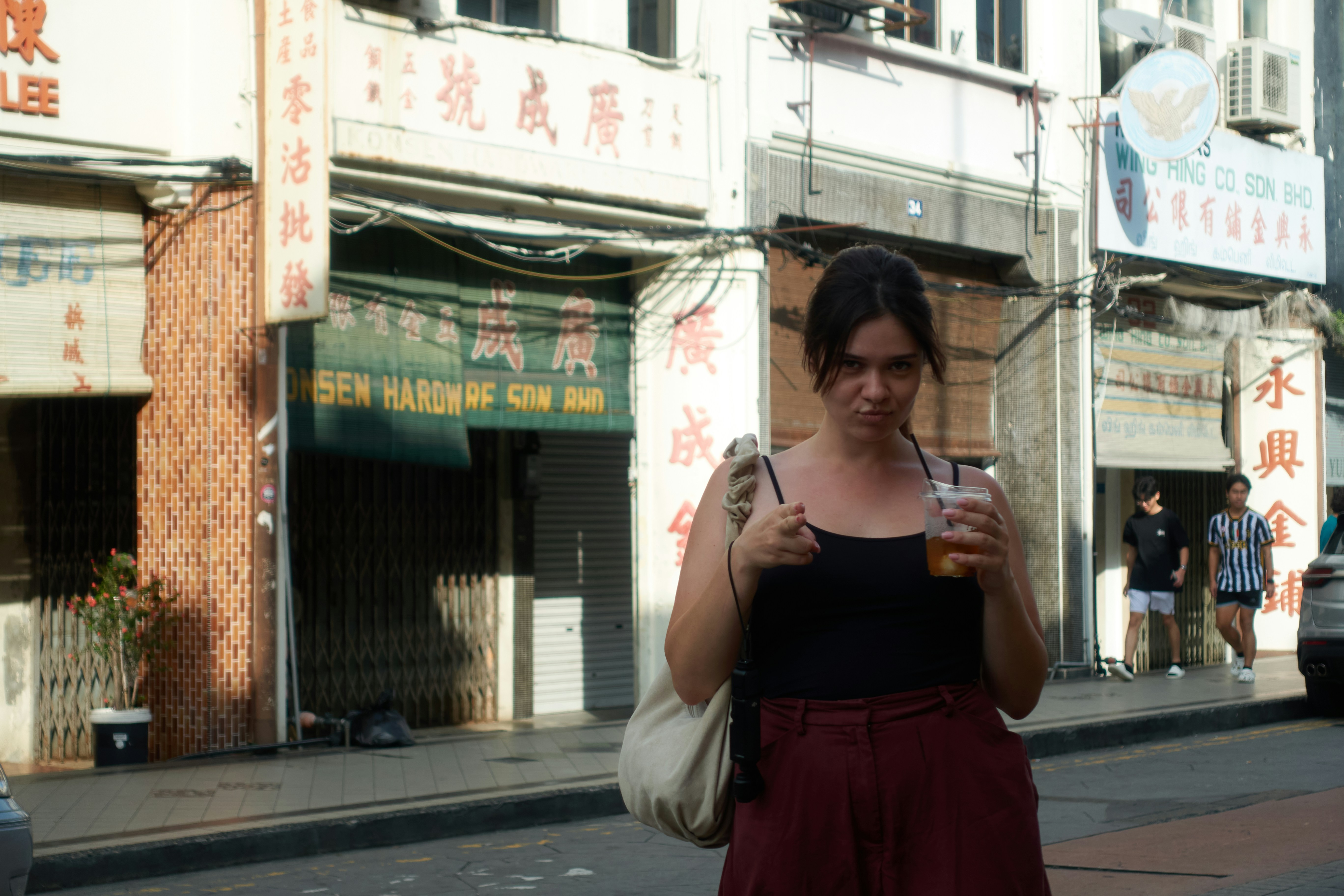An Asian woman walking in an urban setting, representing everyday casual style without glorifying extreme thinness